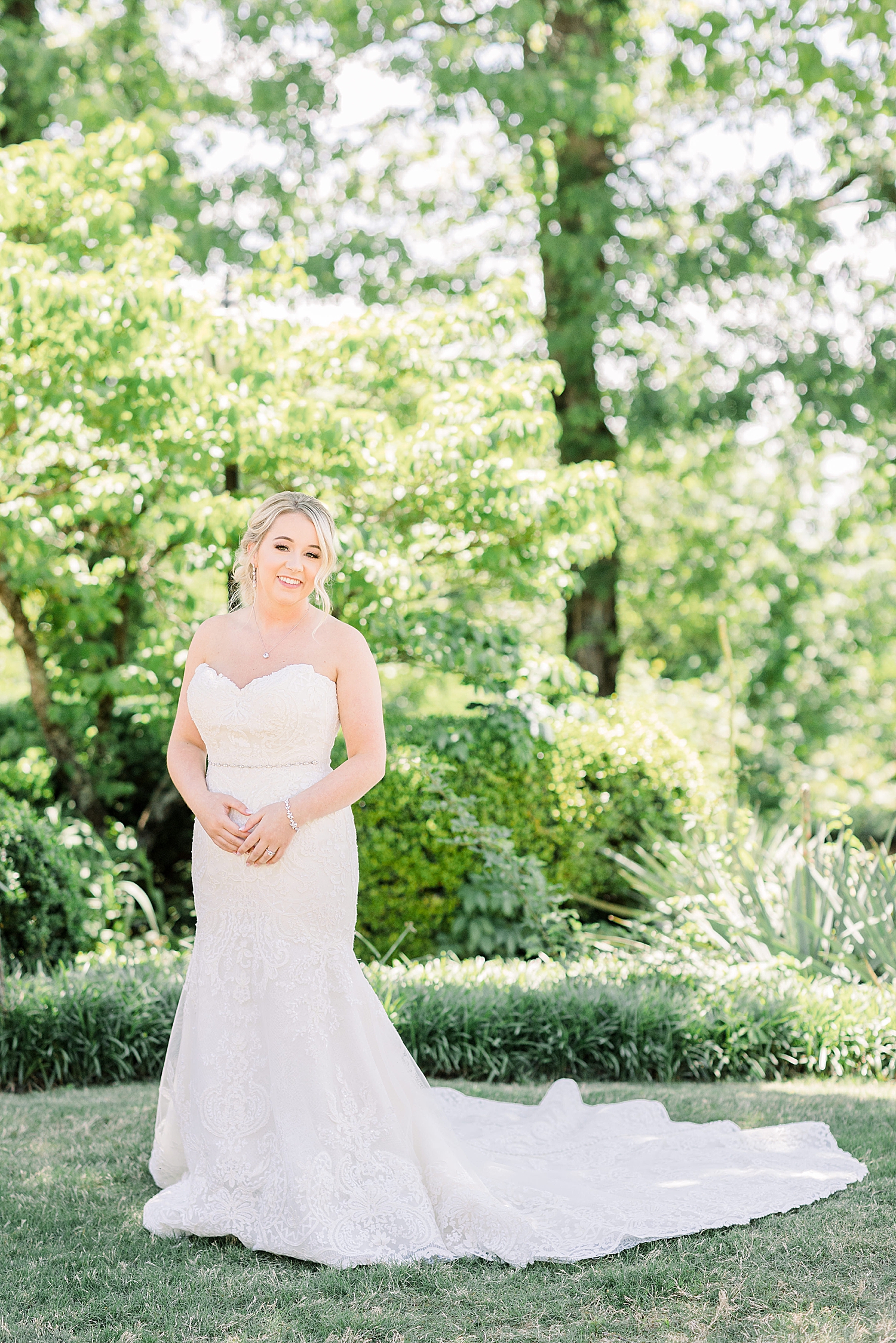 bride poses on lawn at Burritt on the Mountain