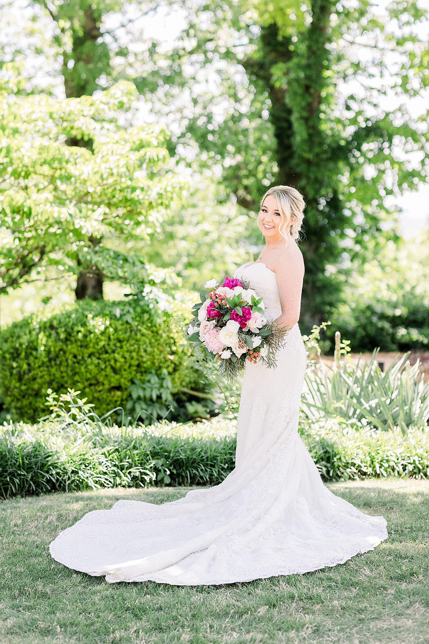 bride holds bouquet of pink and ivory flowers during Huntsville AL wedding