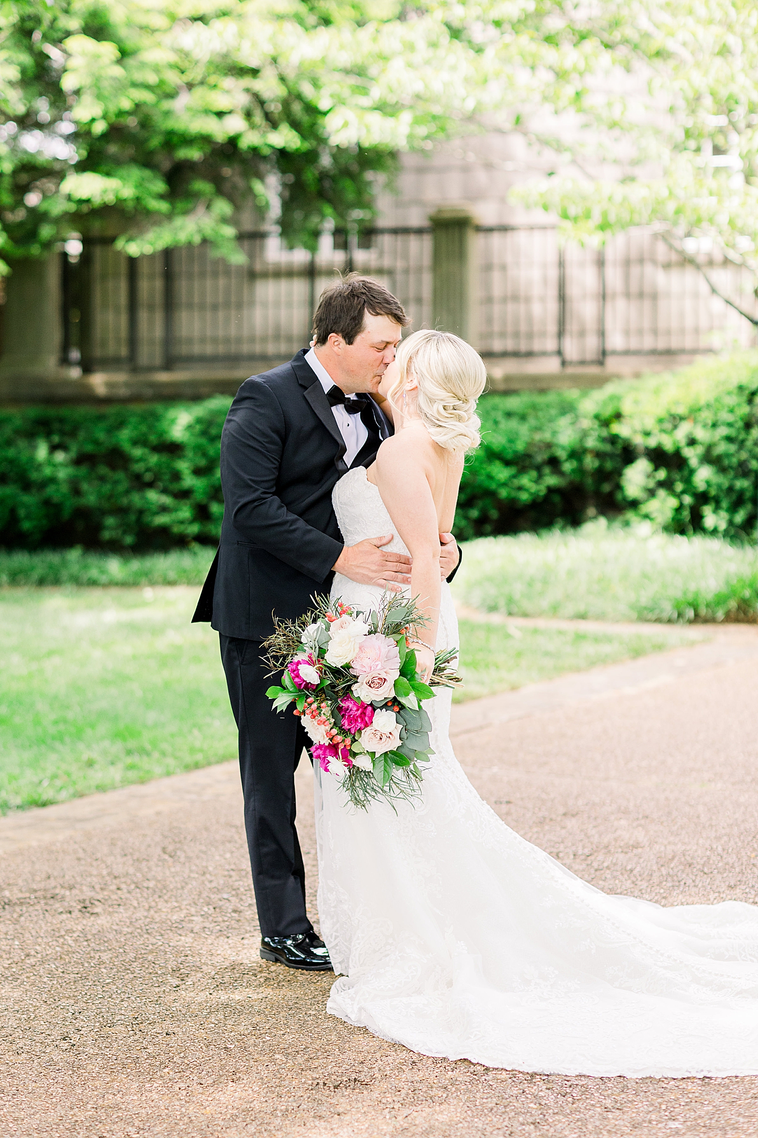 bride and groom kiss during Alabama wedding portraits