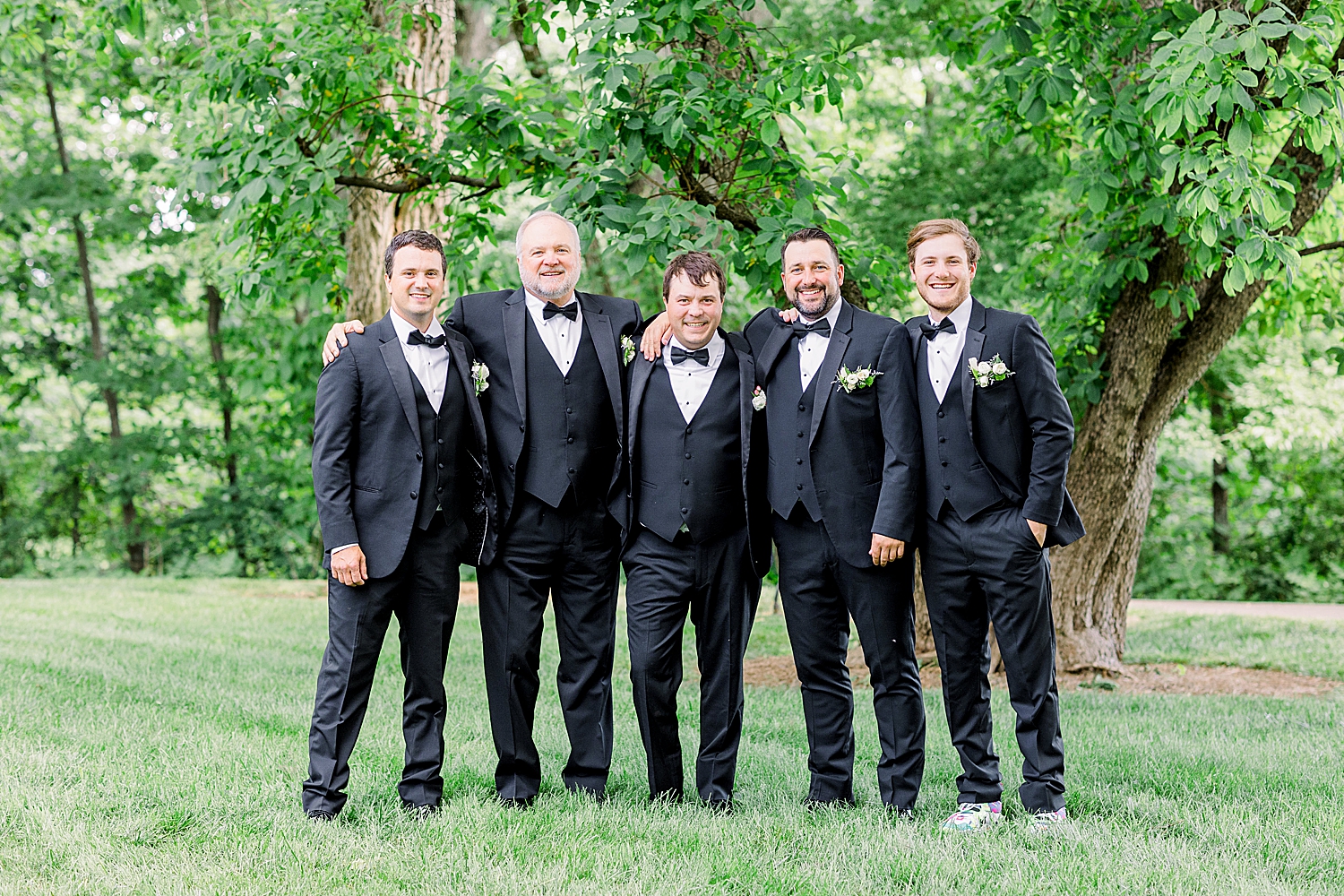 groom poses with groomsmen before Huntsville Al wedding