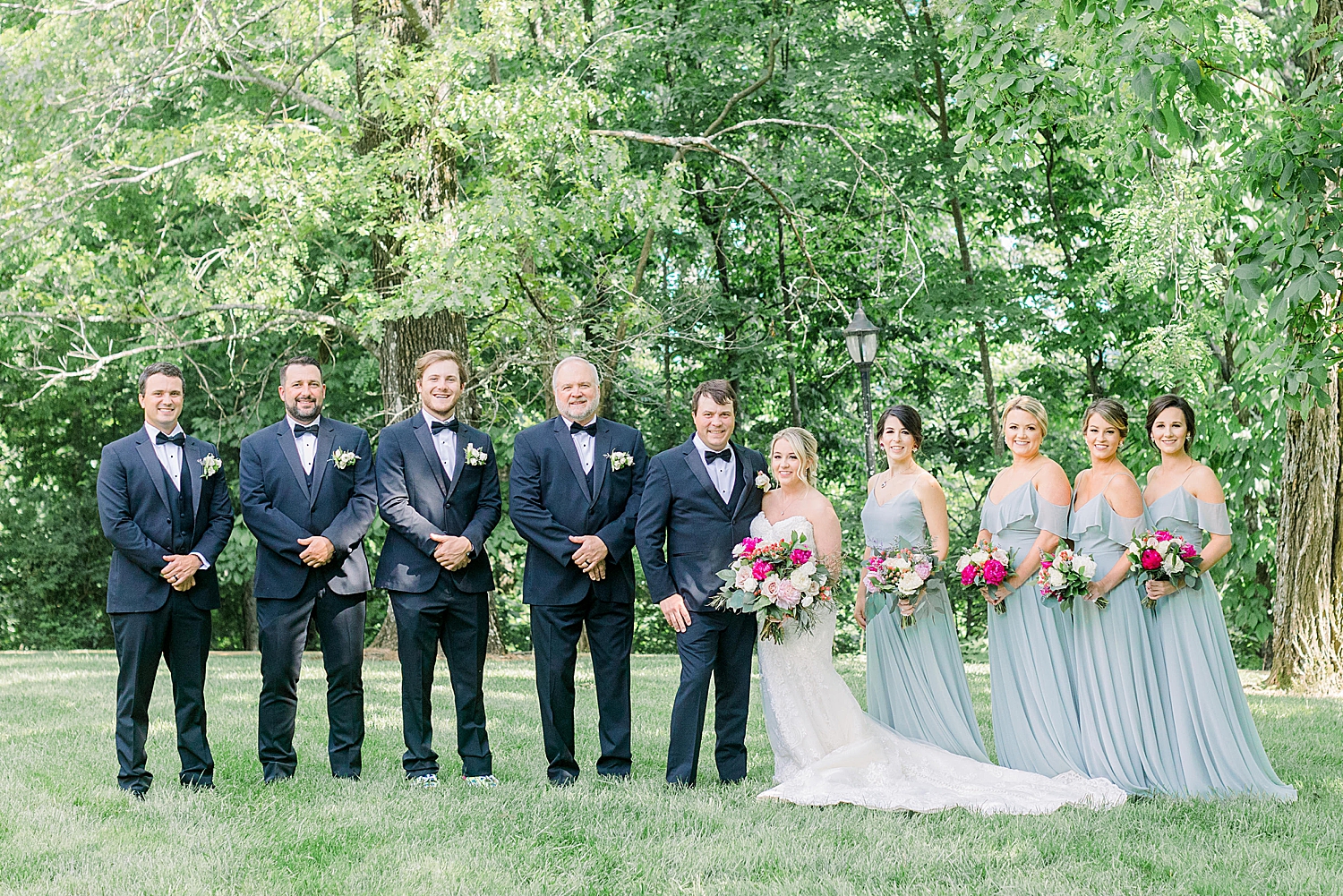 bride and groom pose with bridal party