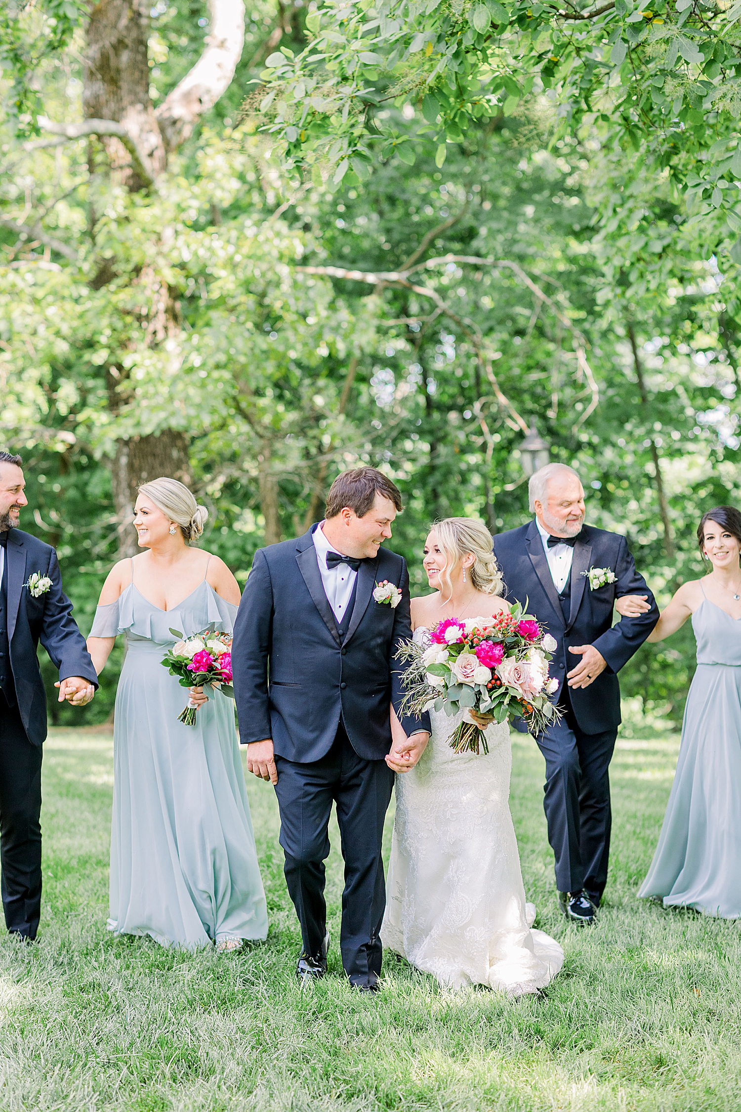newlyweds walk during AL wedding photos