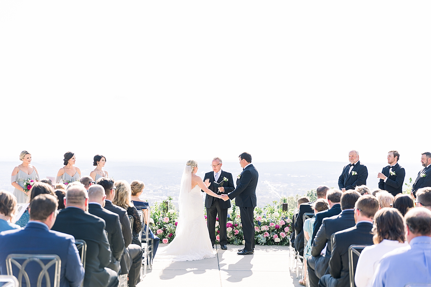 bride and groom hold hands exchanging vows during Huntsville AL wedding ceremony
