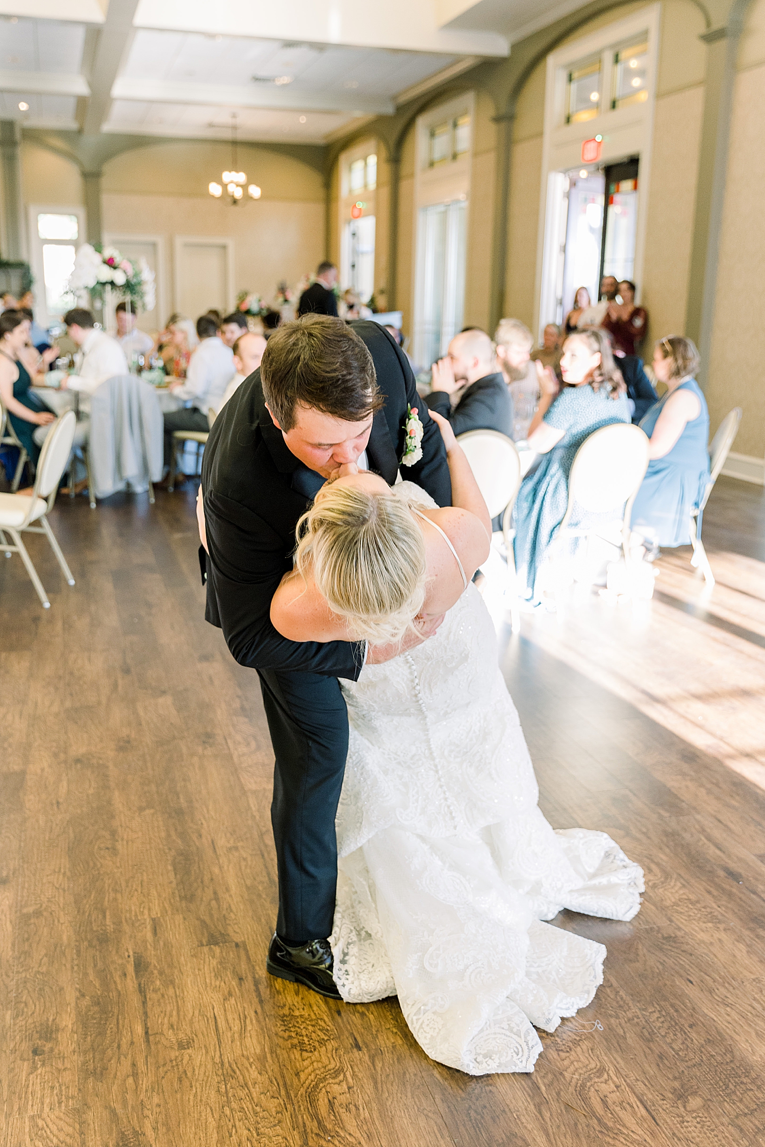 groom dips bride kissing her during Huntsville AL wedding reception