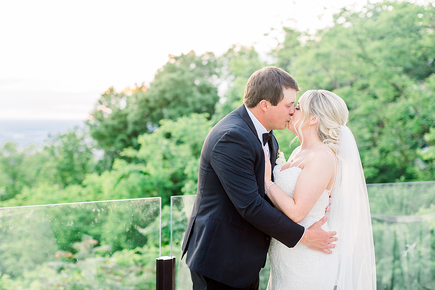 newlyweds kiss during wedding portraits in Huntsville AL