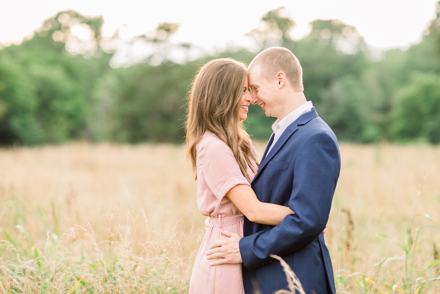 engaged couple stands with noses touching during Montevallo AL engagement portraits