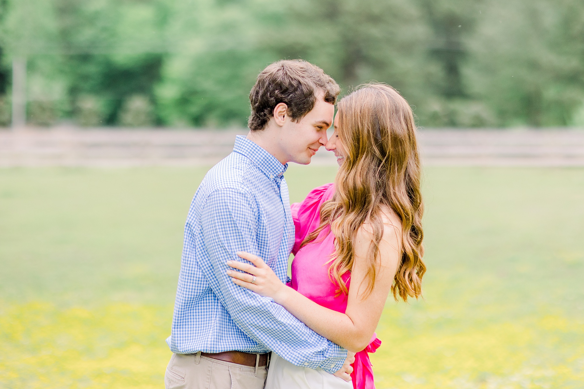 bride and groom stand nose to nose during spring Birmingham AL engagement session