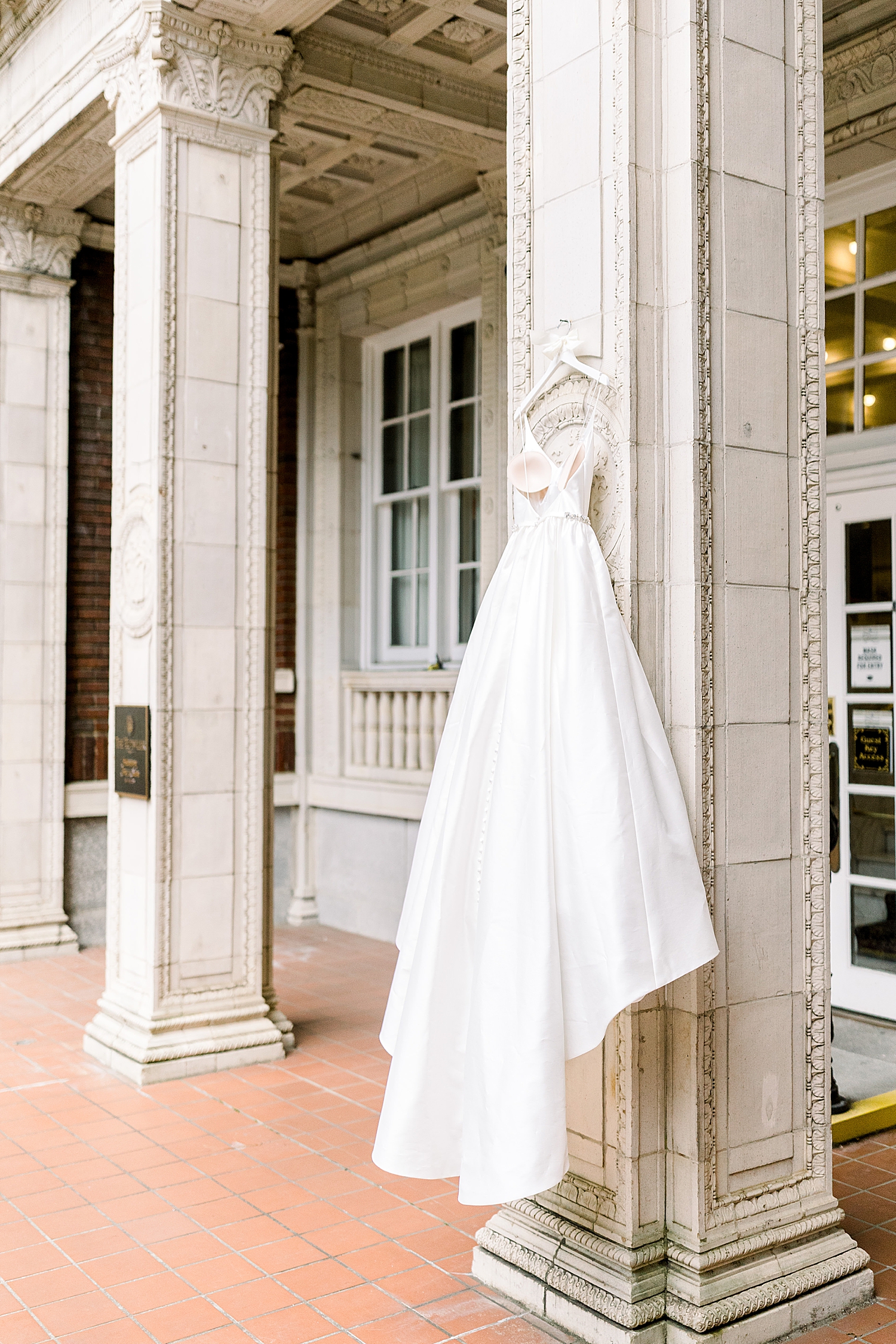 bride's dress hangs outside Tutwiler Hotel