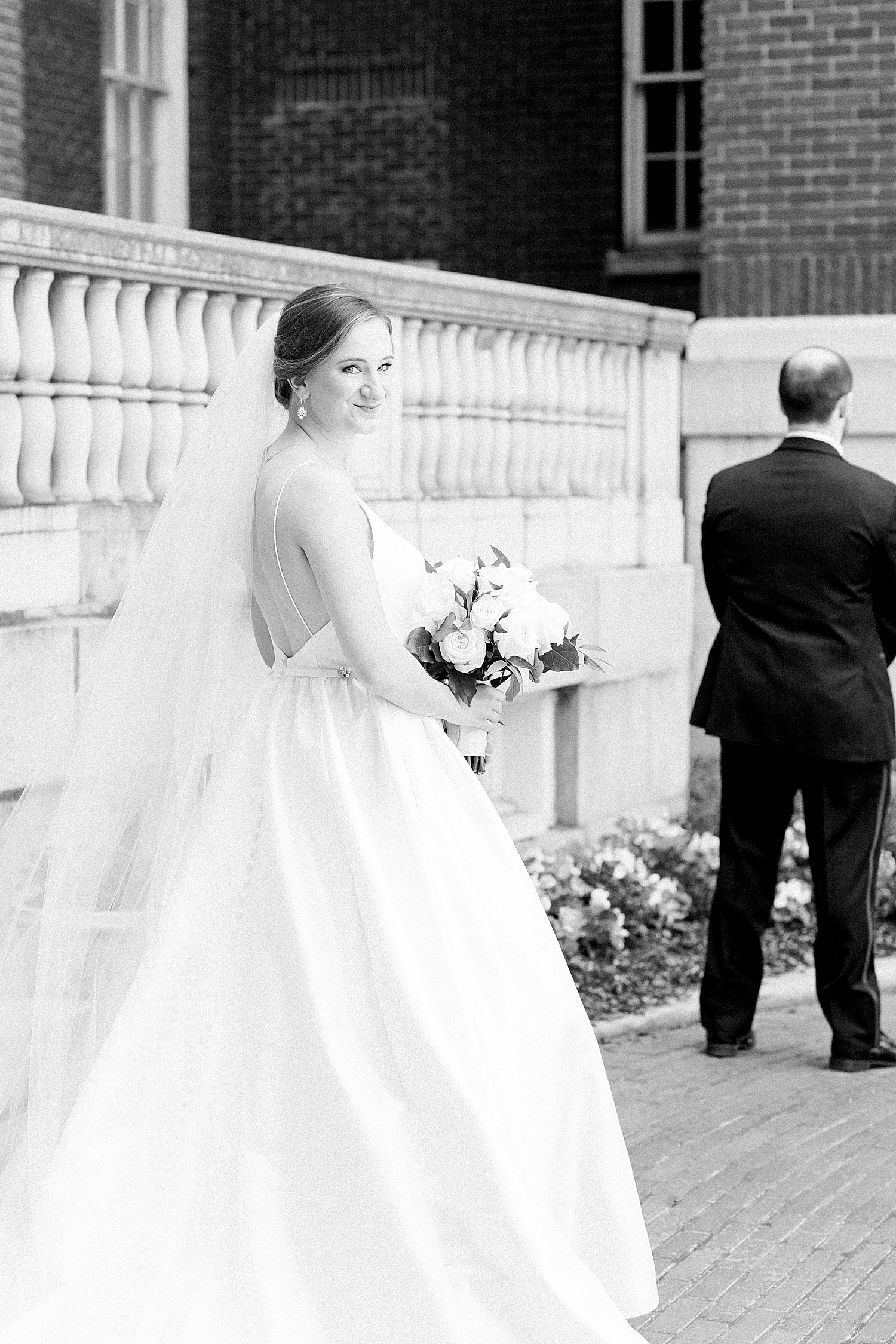 bride approaches groom for first look at Tutwiler Hotel