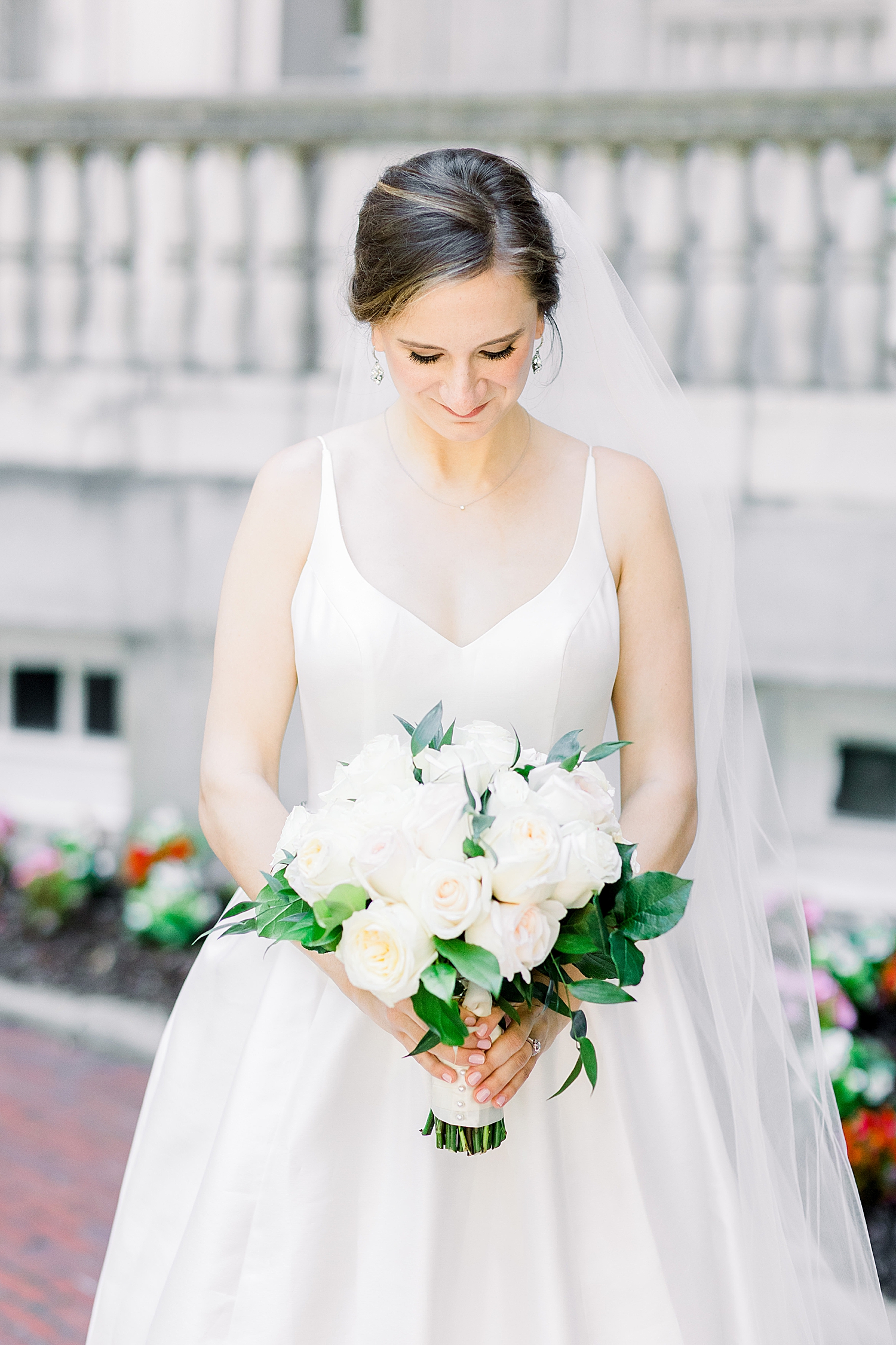 bride looks down at white bouquet during Tutwiler Hotel bridal portraits