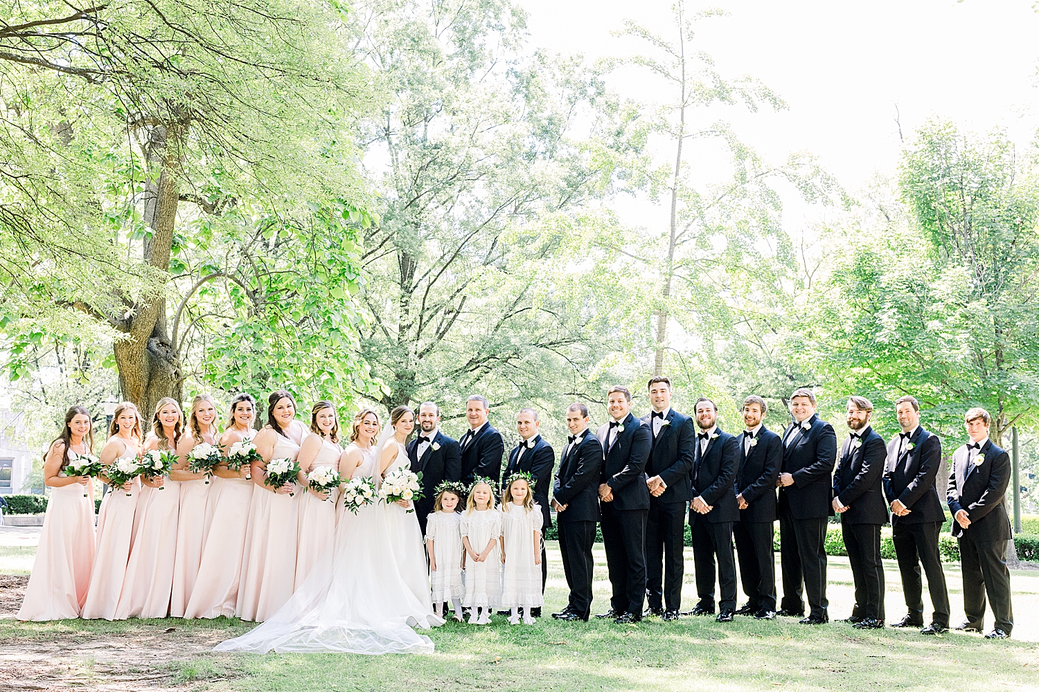 bride and groom pose with bridal party in downtown Birmingham