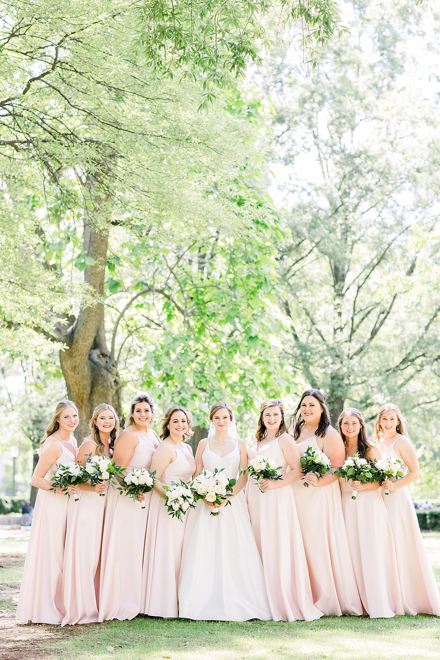 bride and bridesmaids in pink pose in Alabama