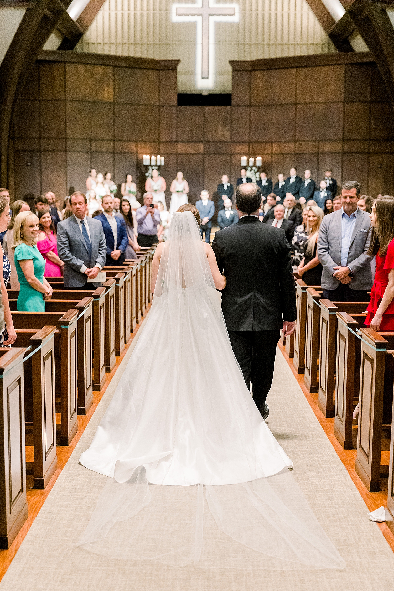 bride walks down aisle with dad at traditional wedding ceremony at Mountain Brook Community Church