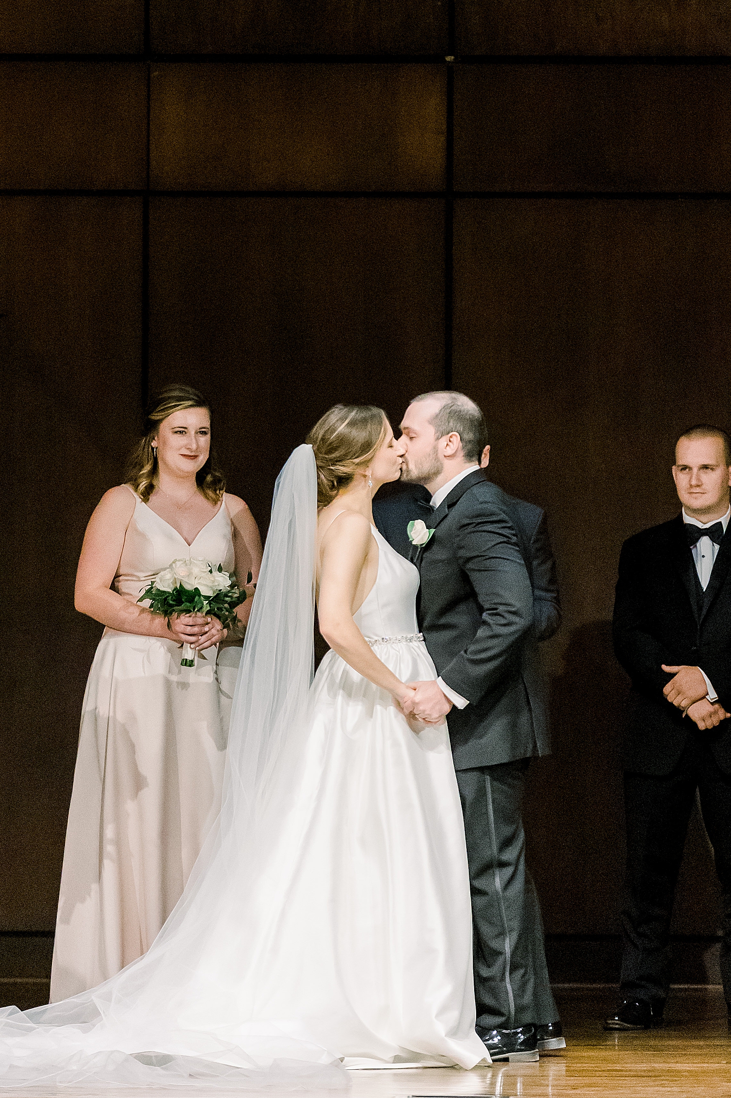 newlyweds kiss during traditional wedding ceremony at Mountain Brook Community Church