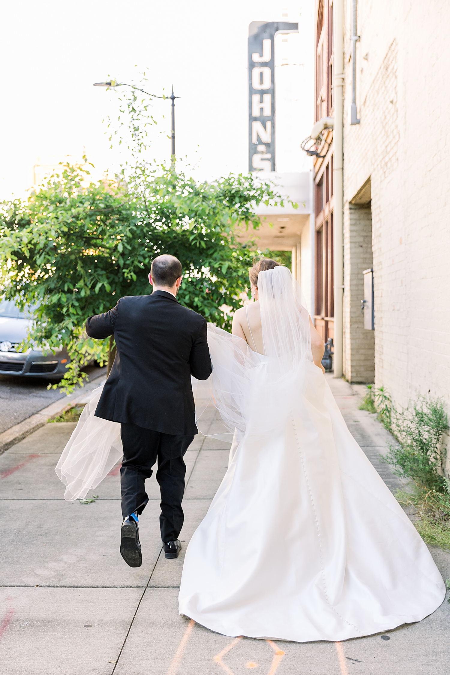 newlyweds walk down street in downtown Birmingham AL