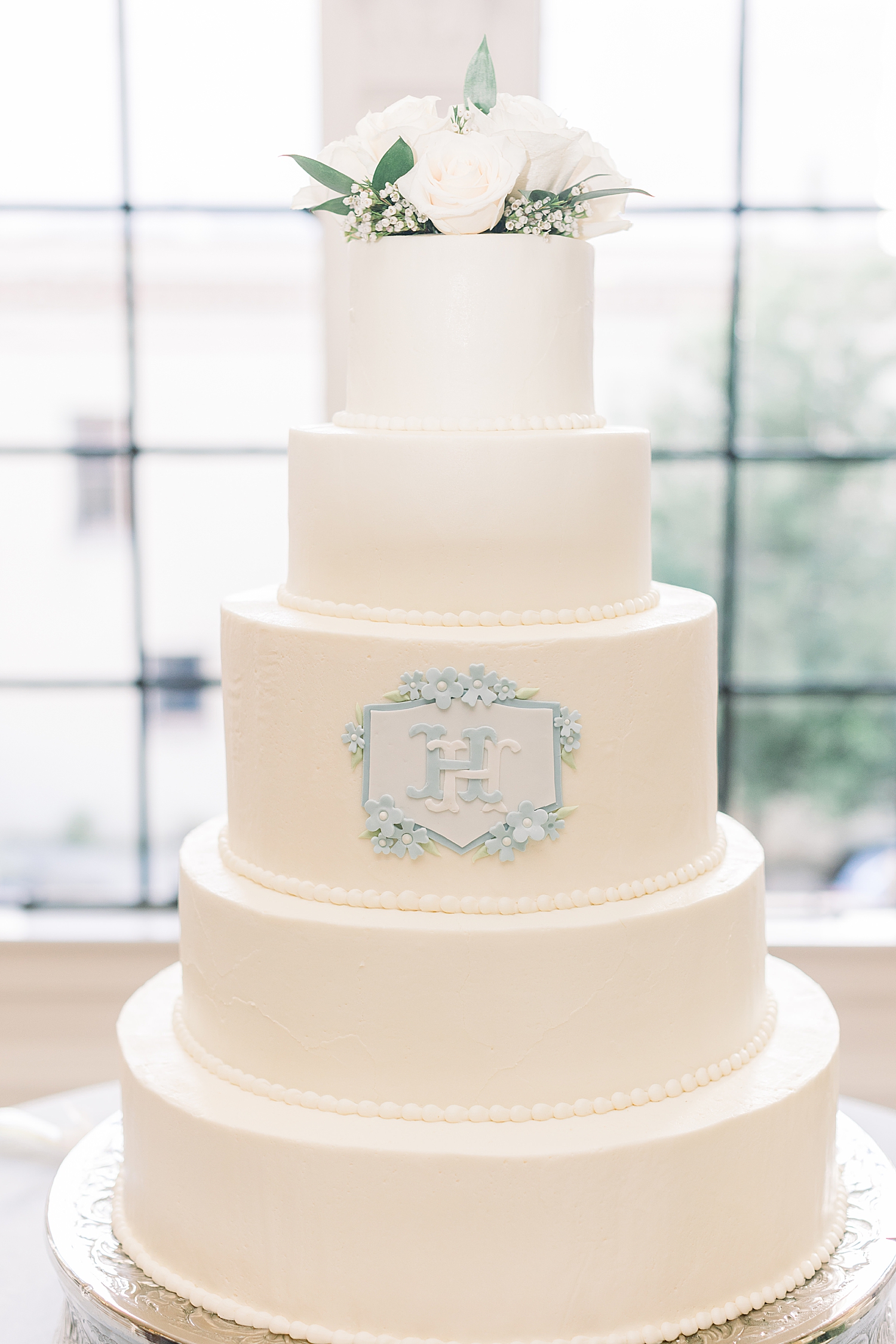 classic wedding cake with light blue details at The Florentine Building wedding reception