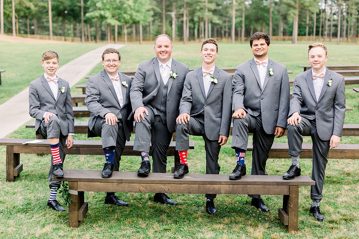 groom and groomsmen show off funny socks on wedding day