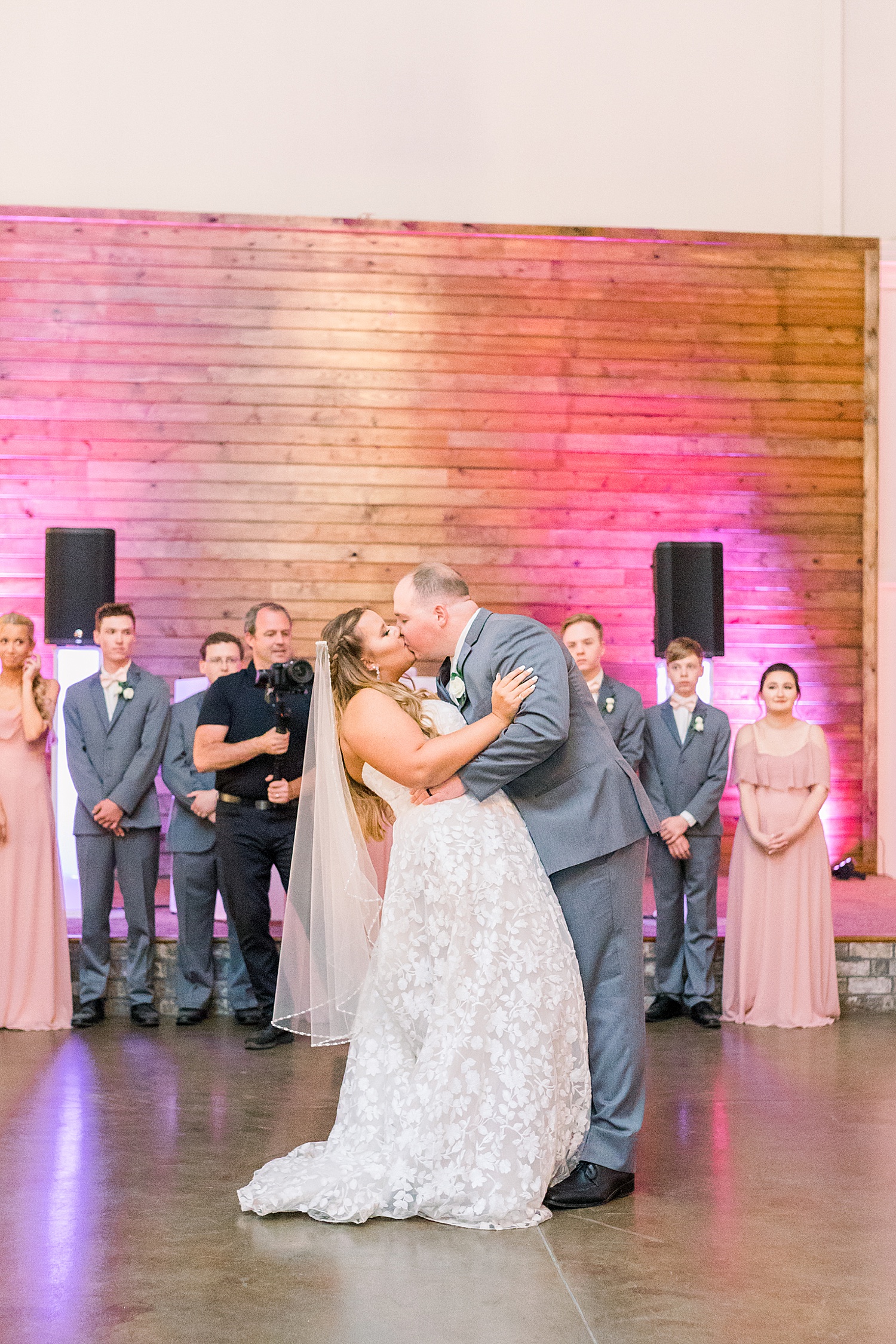 groom kisses bride on dance floor during Birmingham AL wedding reception