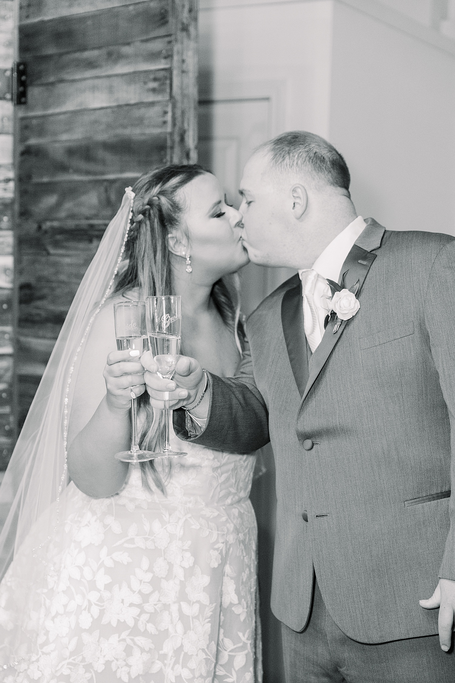 bride and groom kiss during champagne toast