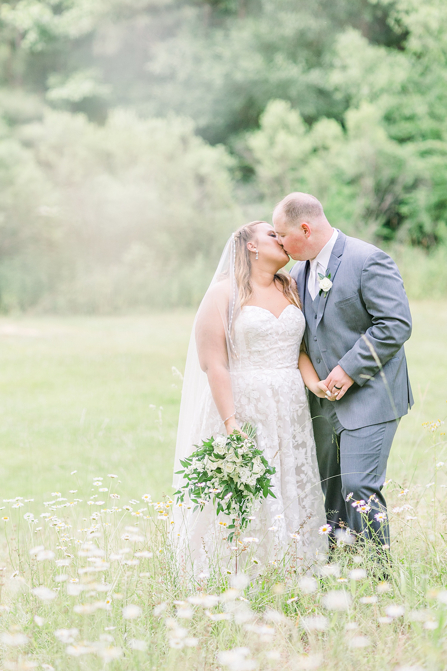 newlyweds kiss in field in Alabama
