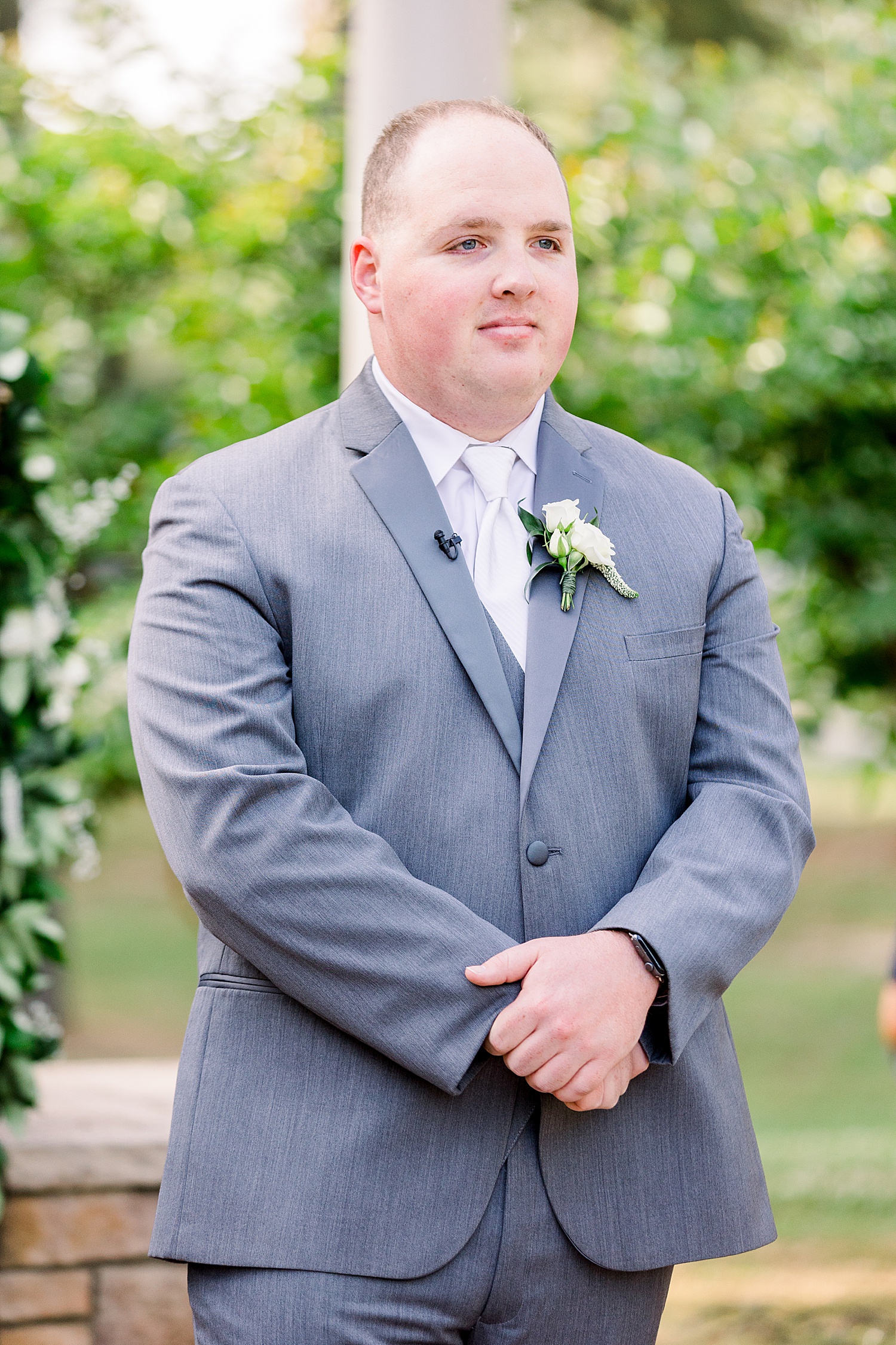 groom watches bride walk down aisle during outdoor ceremony at Douglas Manor