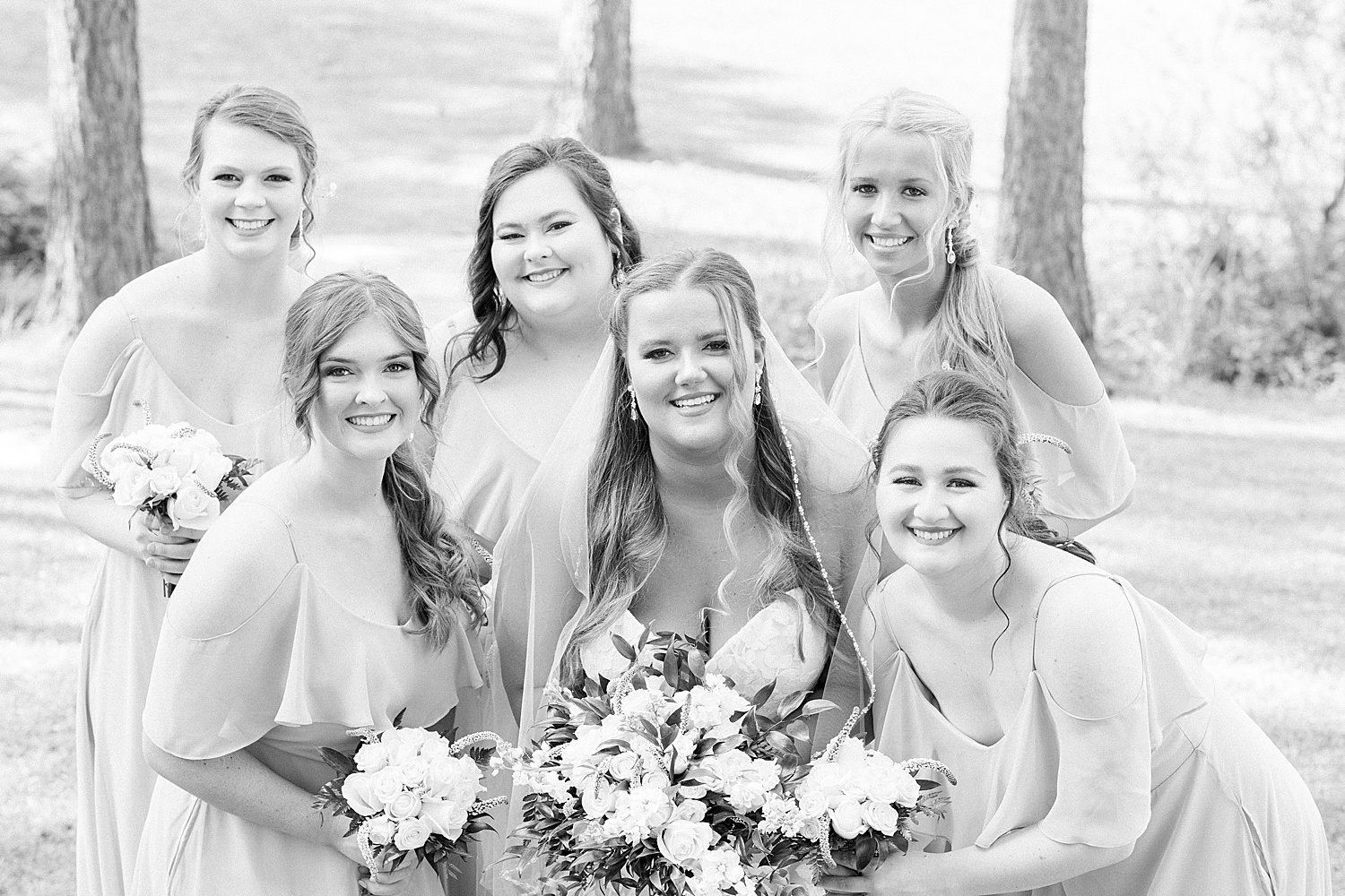 bride poses with bridesmaids before Douglas Manor wedding