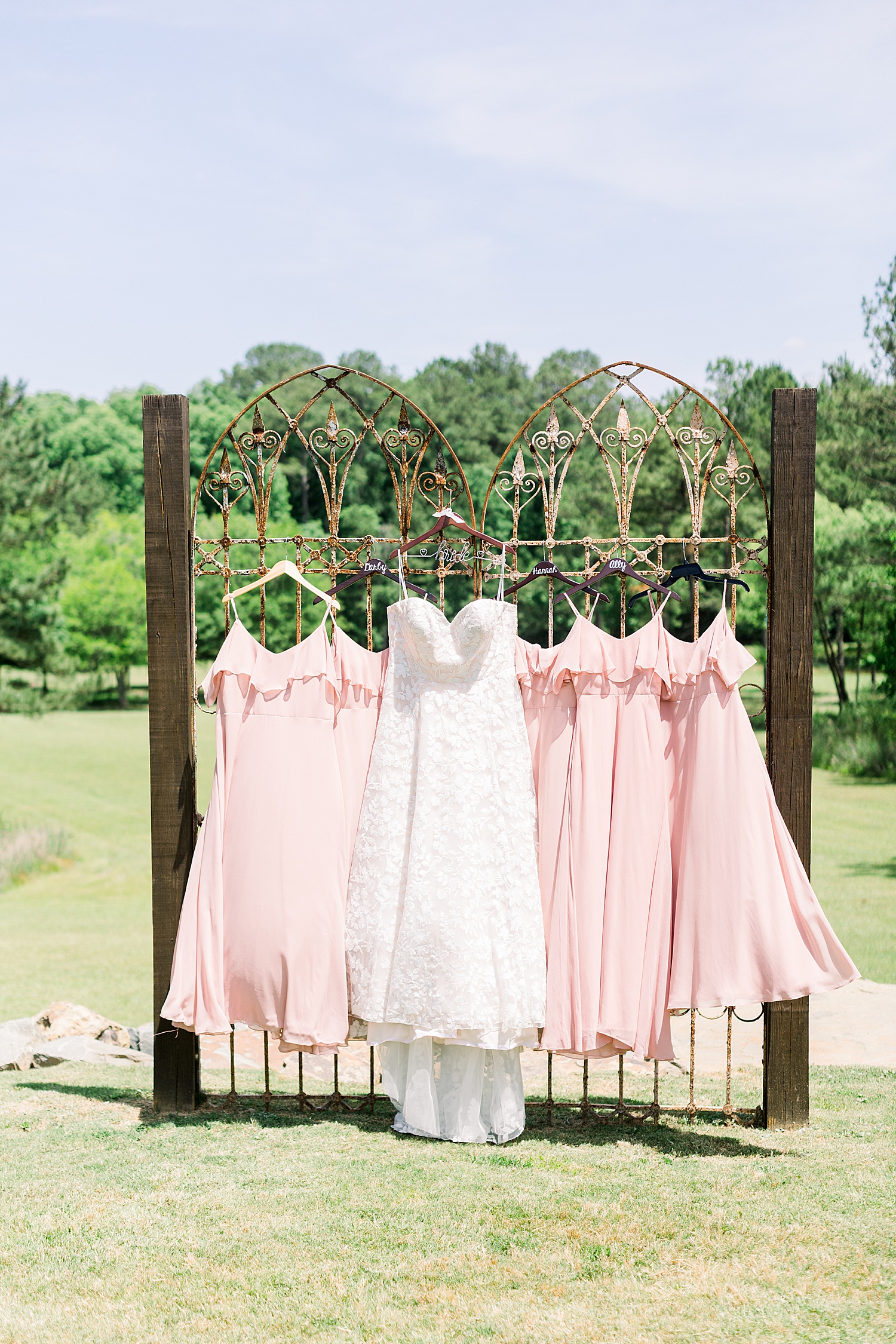 wedding dress hangs with pink bridesmaid dresses before Douglas Manor wedding