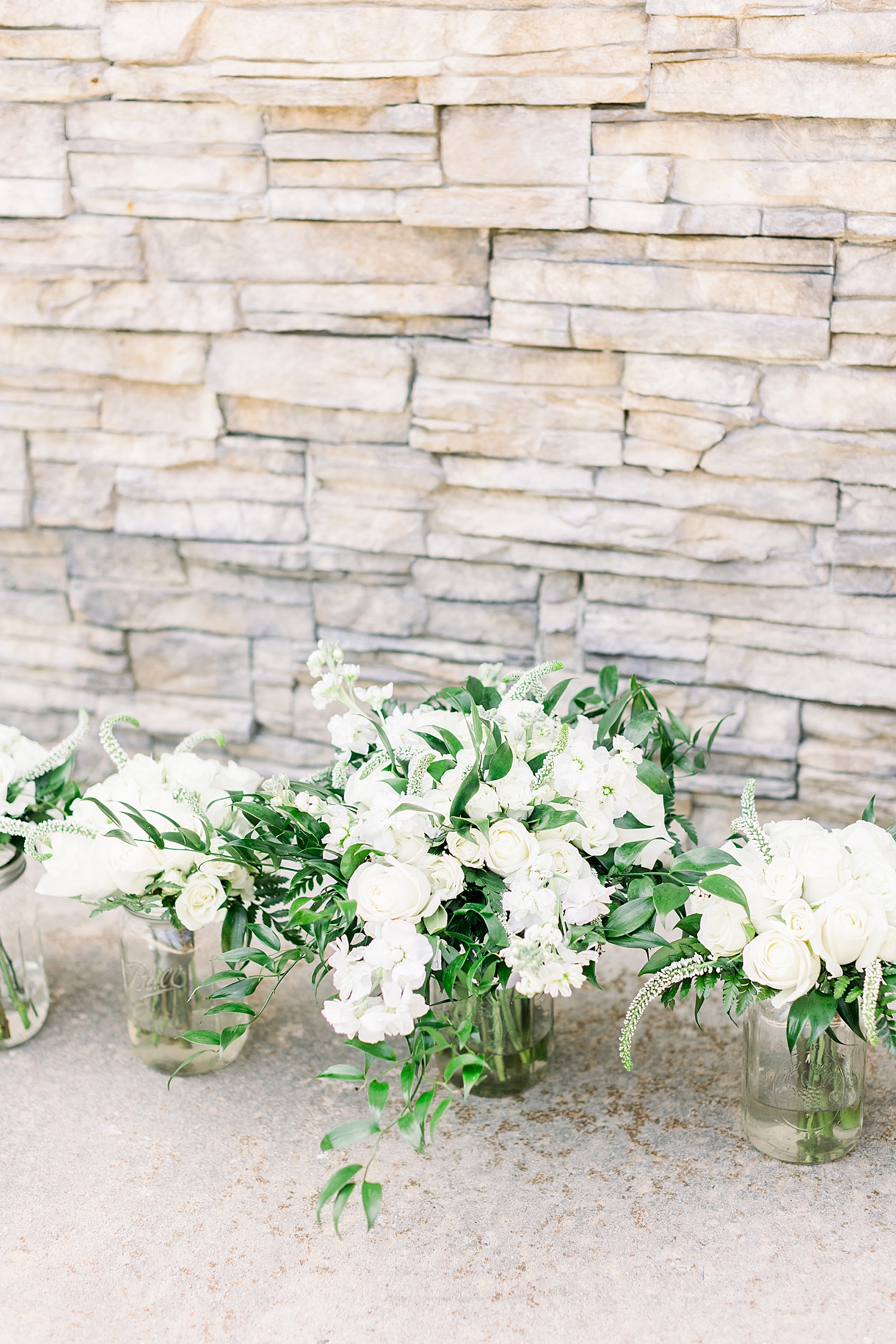 wedding bouquets by stone wall at Douglas Manor