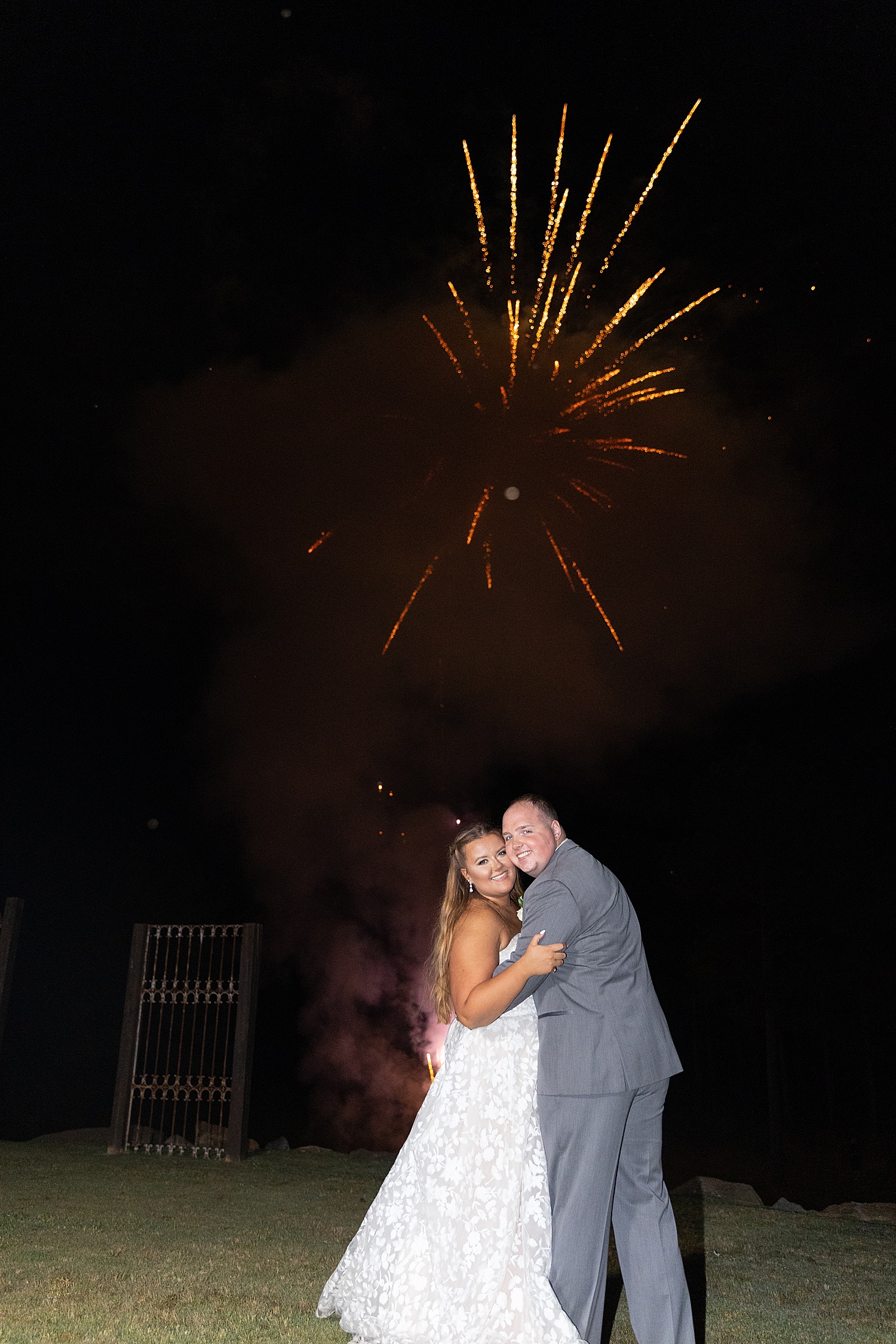 newlyweds pose with cheeks touching during Birmingham AL wedding fireworks