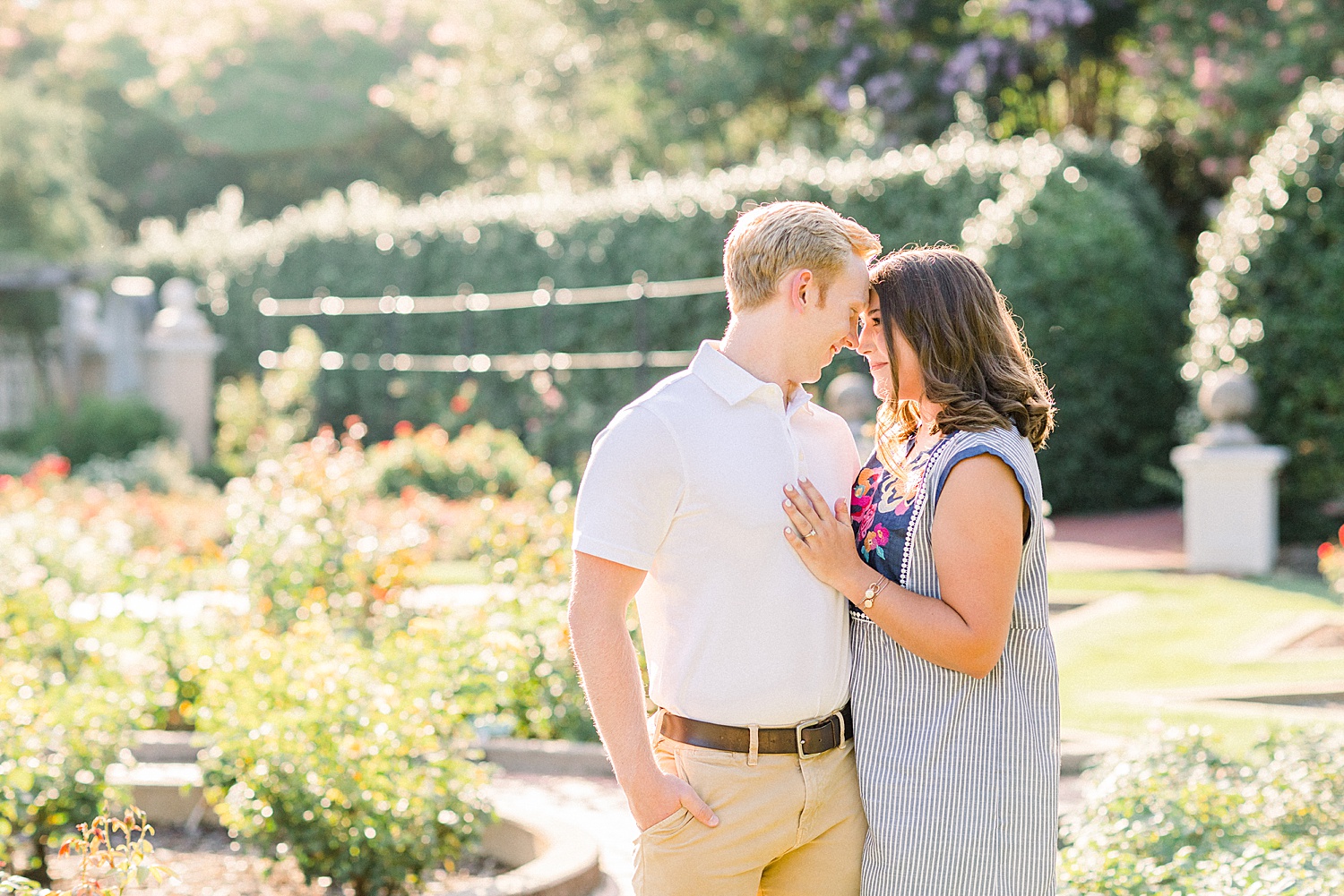bride and groom stand together touching noses during photos in Birmingham Botanical Gardens