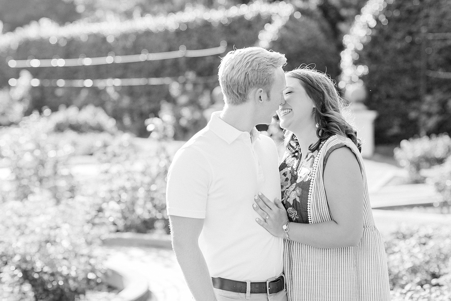 bride and groom kiss in gardens during Downtown Birmingham engagement session