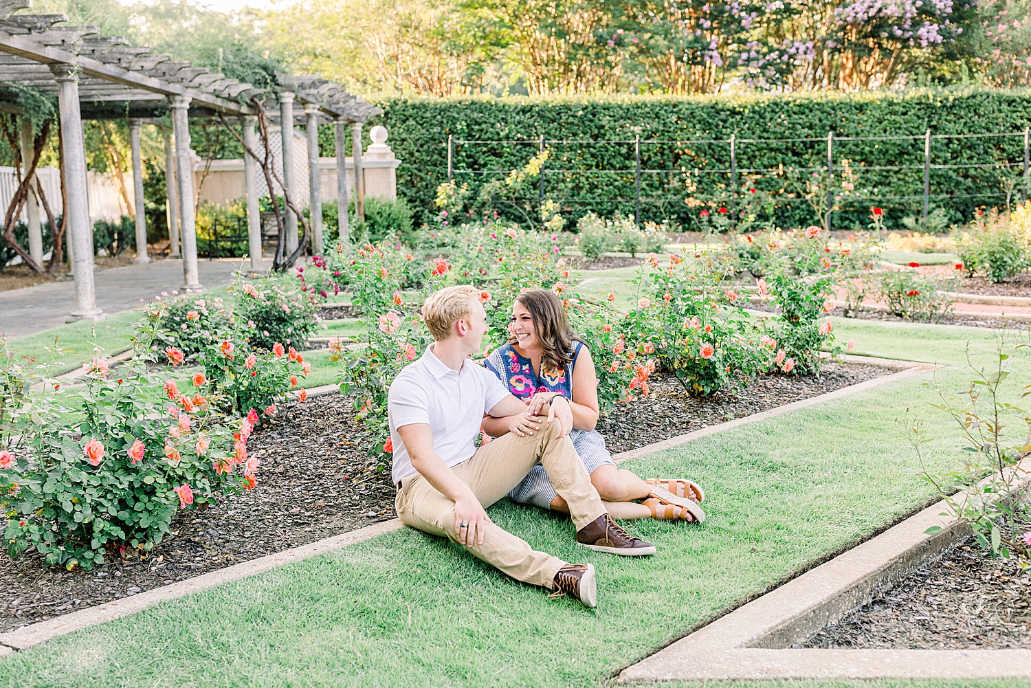 engaged couple sits in garden at Birmingham Botanical Gardens