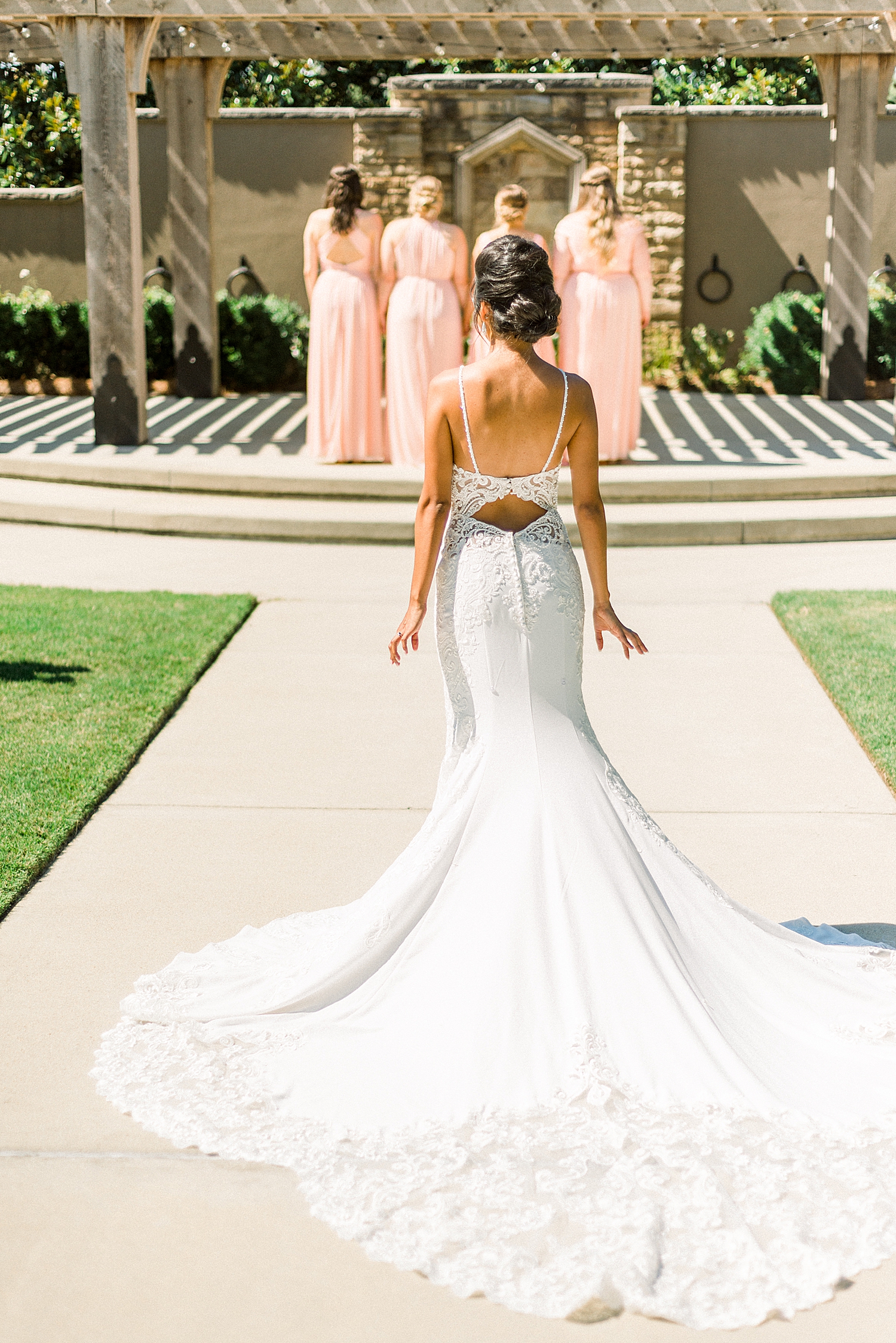 bride walks to bridesmaids for first look before Preserve Town Hall wedding