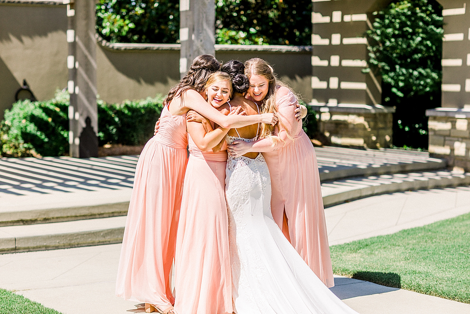 bridesmaids hug bride after first look in Alabama
