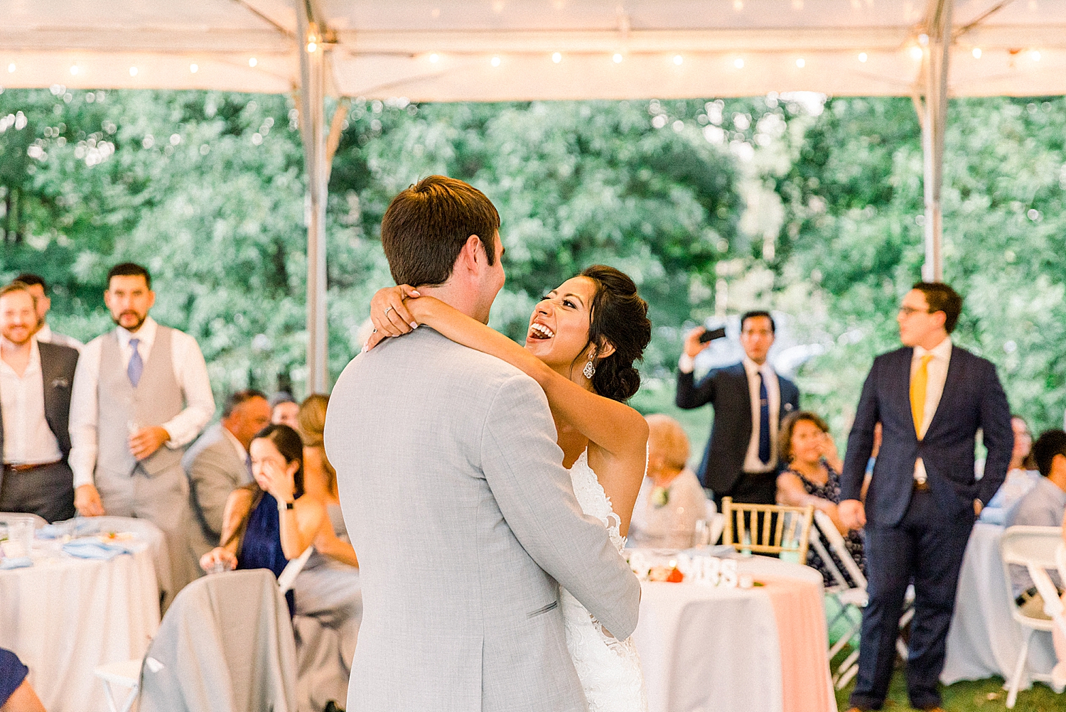 bride and groom dance during tented Preserve Town Hall wedding reception
