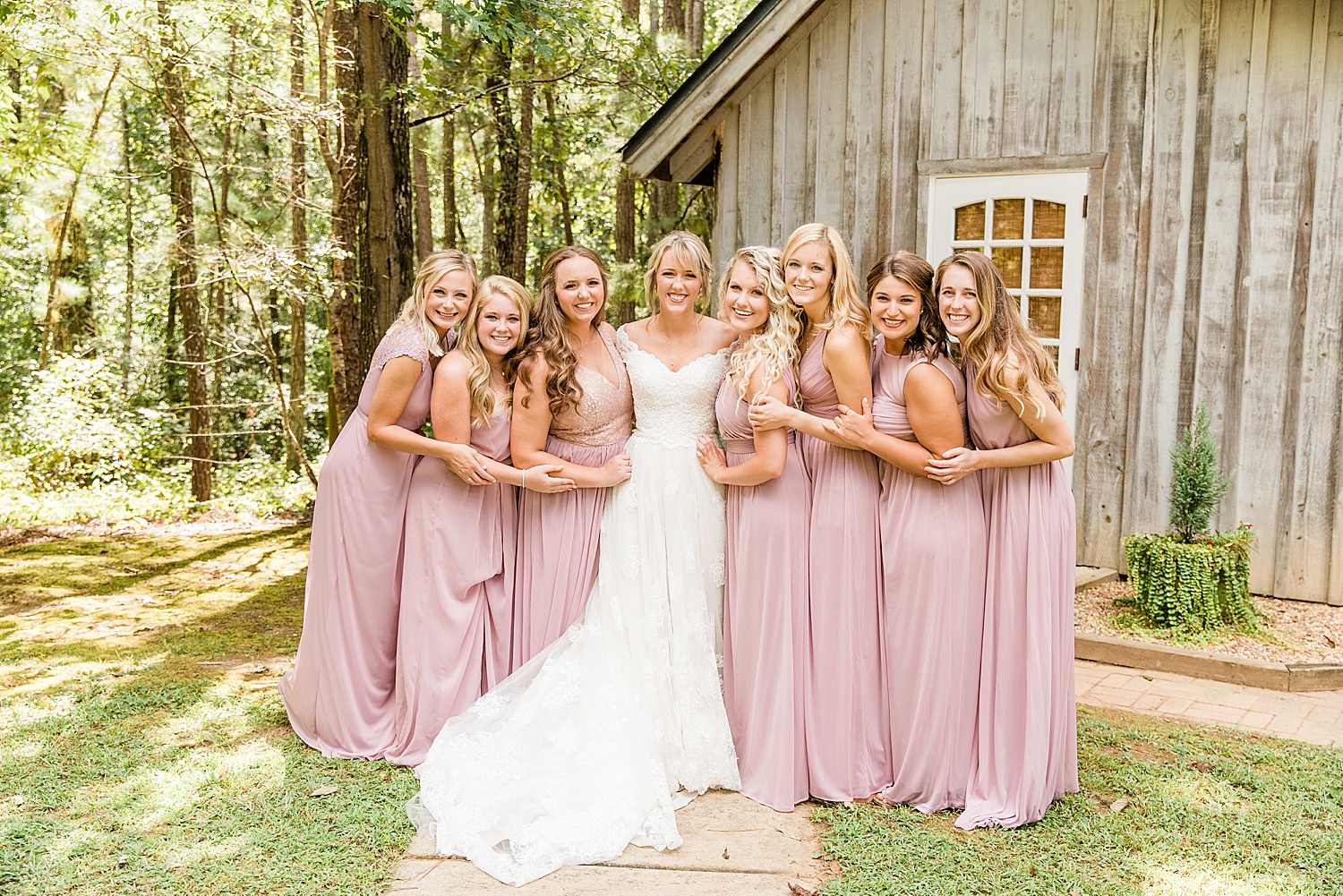 Bride and Bridesmaids in dusty pink dresses before Applewood Farms AL Wedding