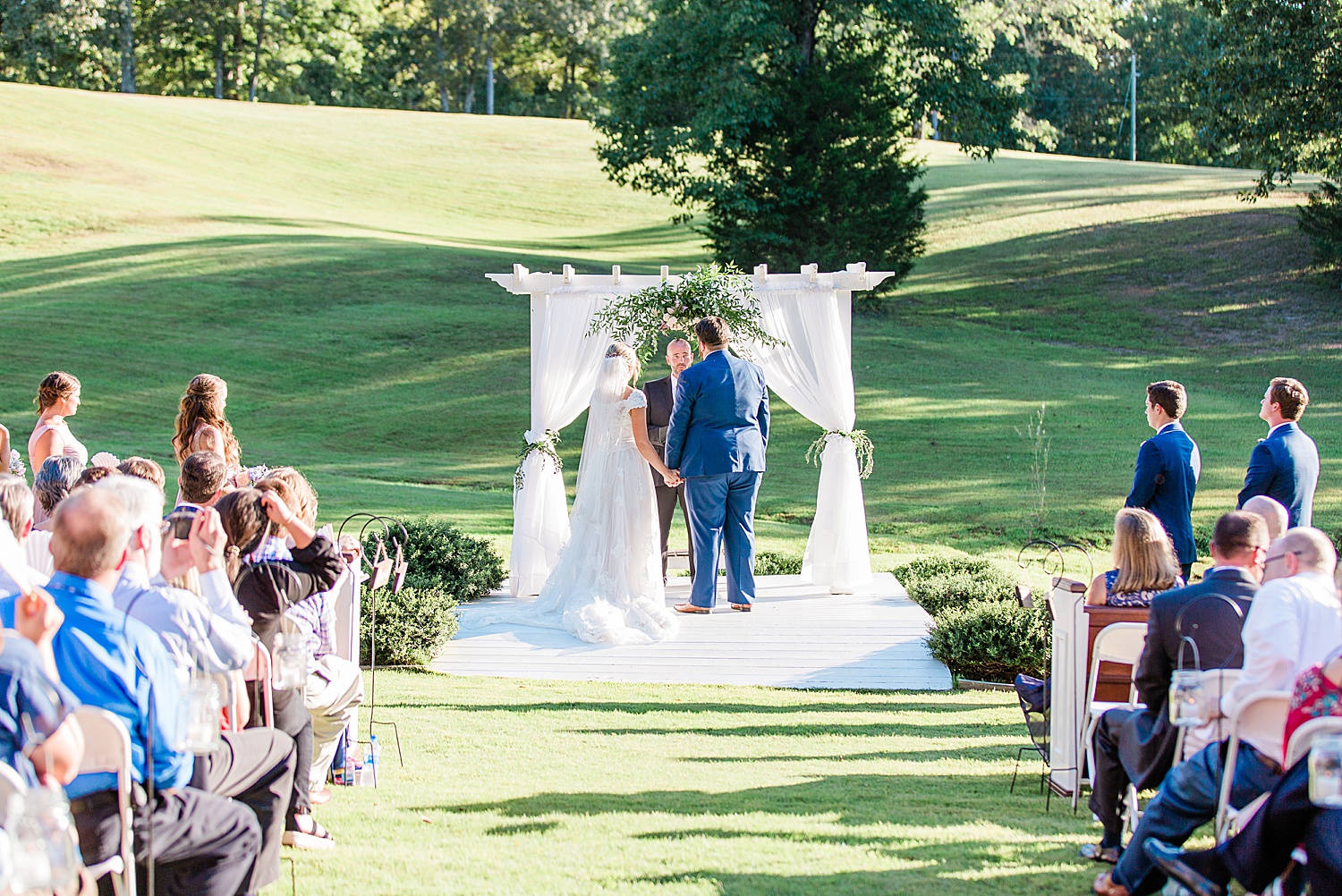 couple at wedding alter during ceremony at Alabama applewood farms wedding by chelsea morton photography
