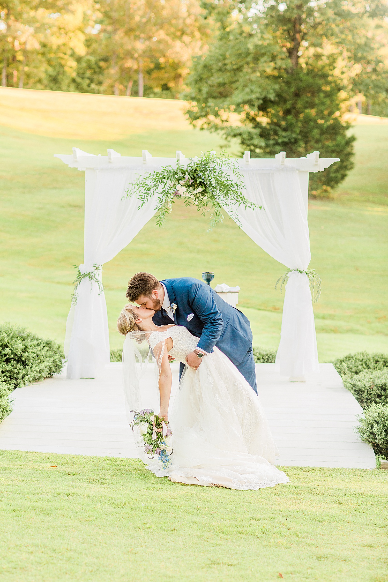 Groom kisses bride at alter during Applewood Farms Wedding by Chelsea Morton Photography