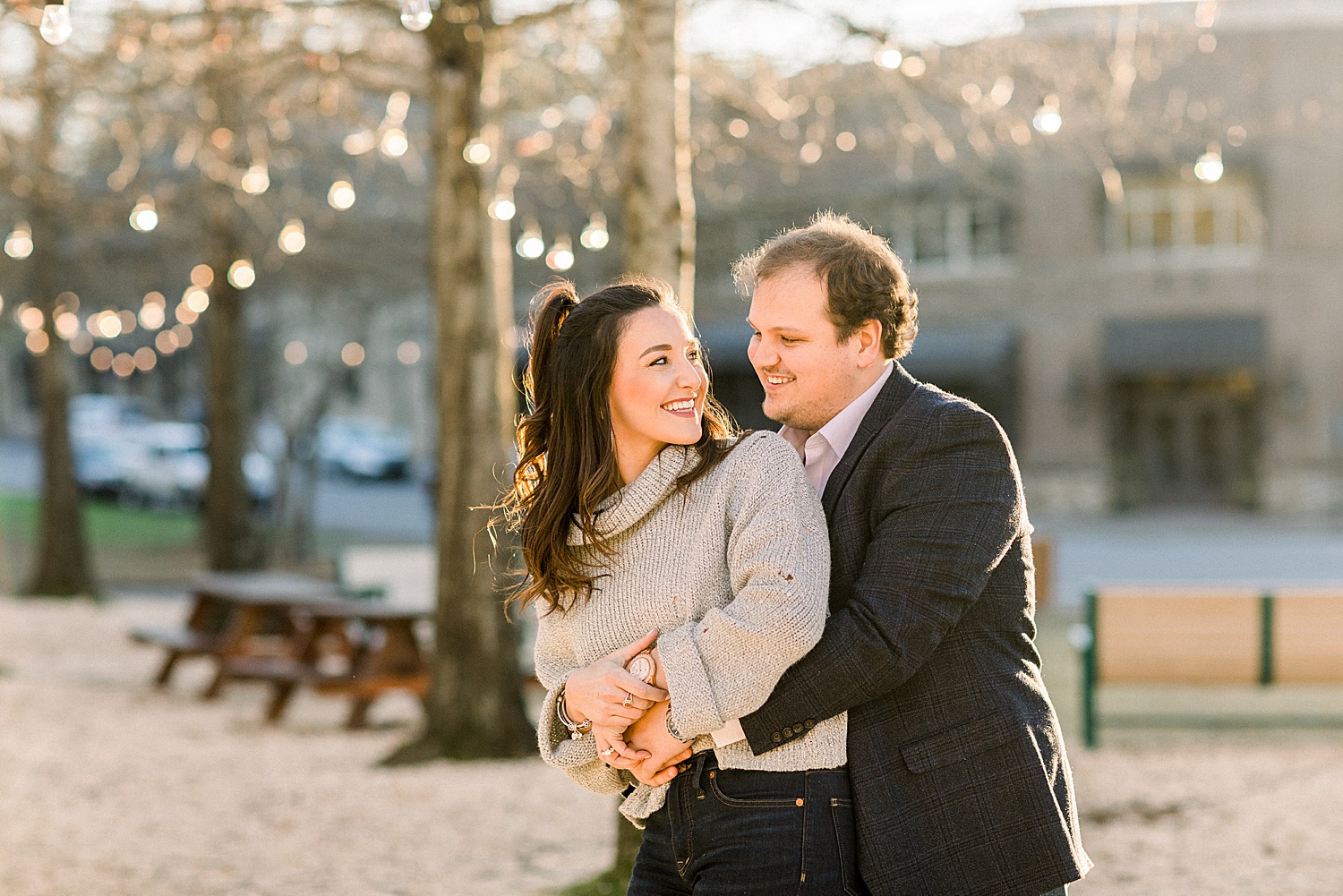 couple dances and laughs in grass during Mount Laurel Engagement Session in Birmingham AL by Chelsea Morton Photography