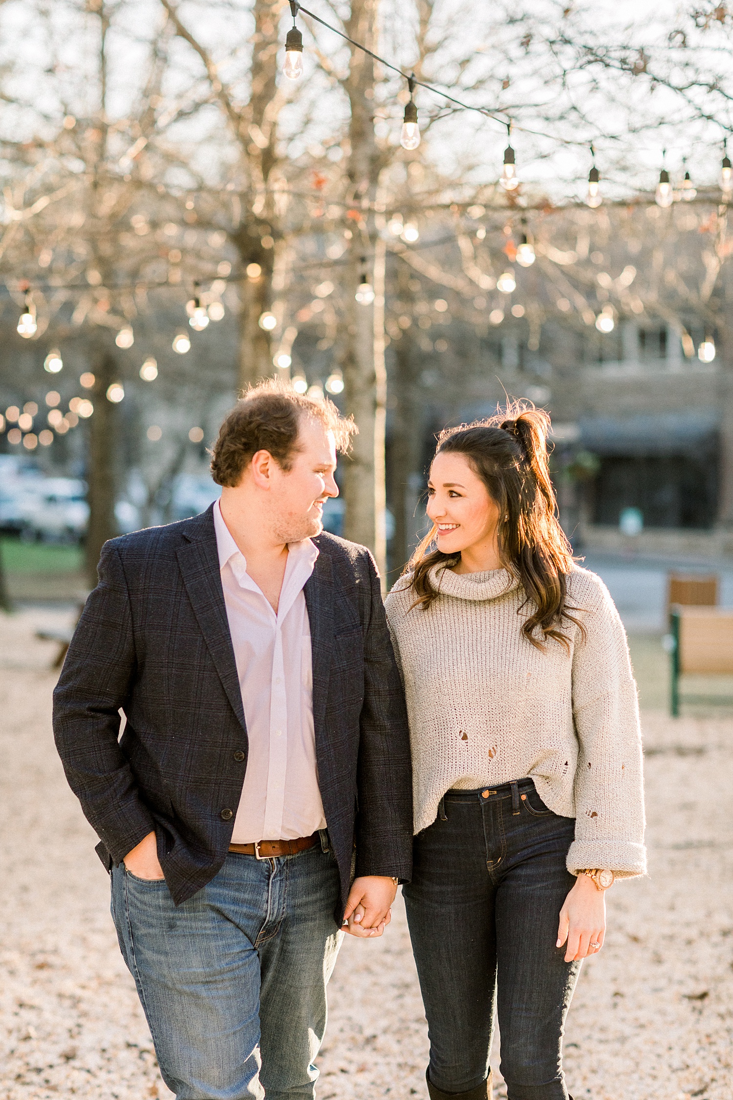 engaged couple stand under lights during Mount Laurel Engagement Session in Birmingham AL by Chelsea Morton Photography