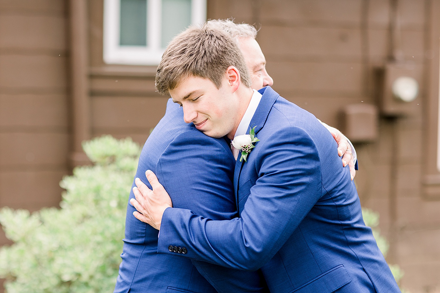 groom and father hug before AL wedding ceremony captured by Chelsea Morton photography