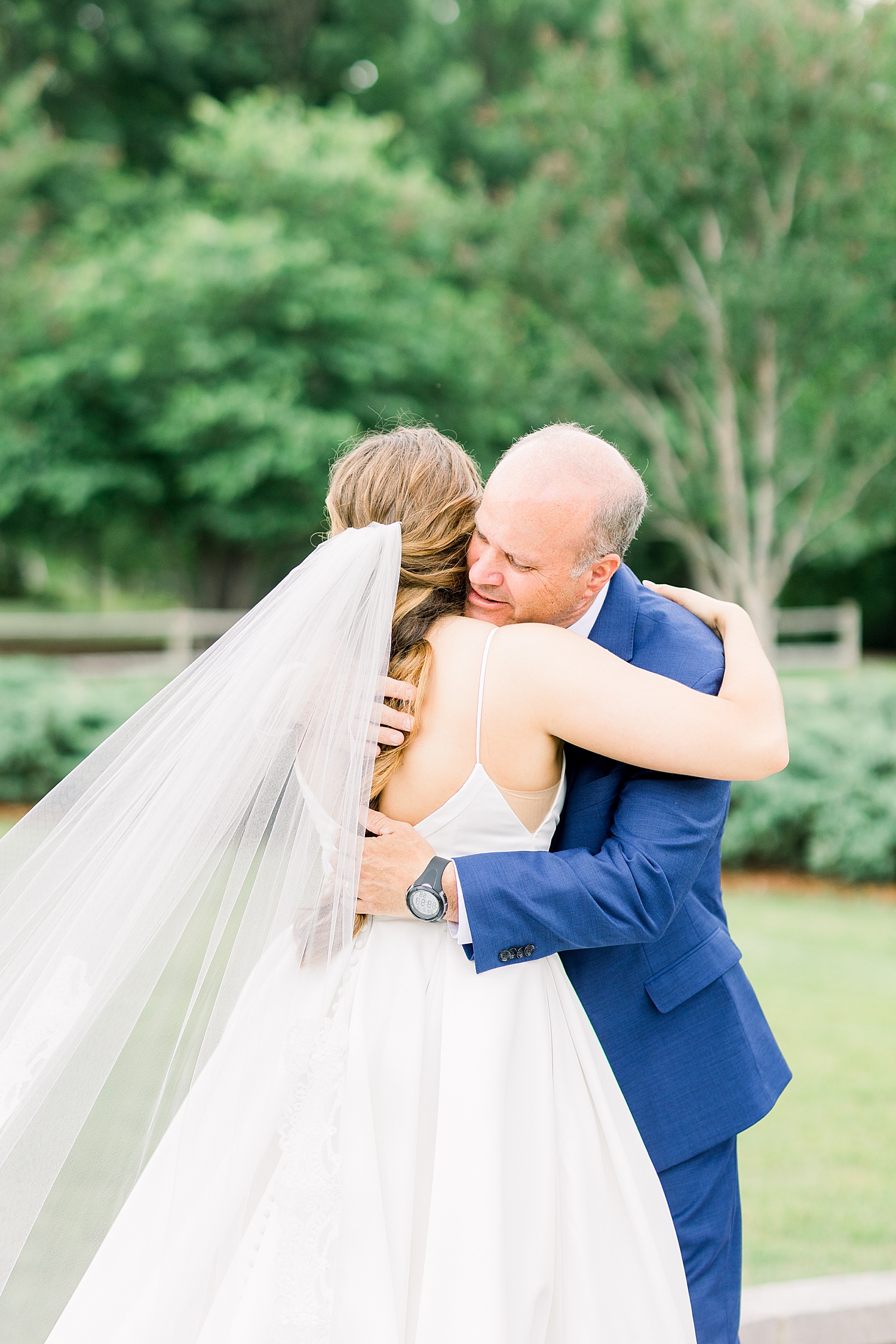Bride and her father hug during first look with dad before AL wedding ceremony