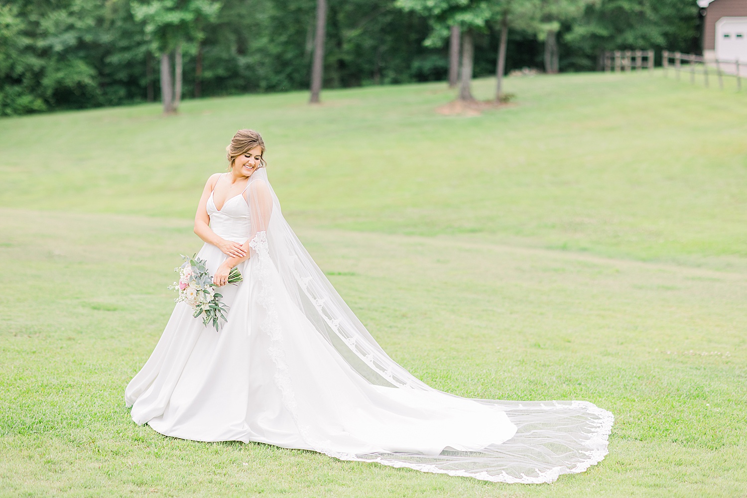 Bride in green field of grass before Alabama wedding ceremony