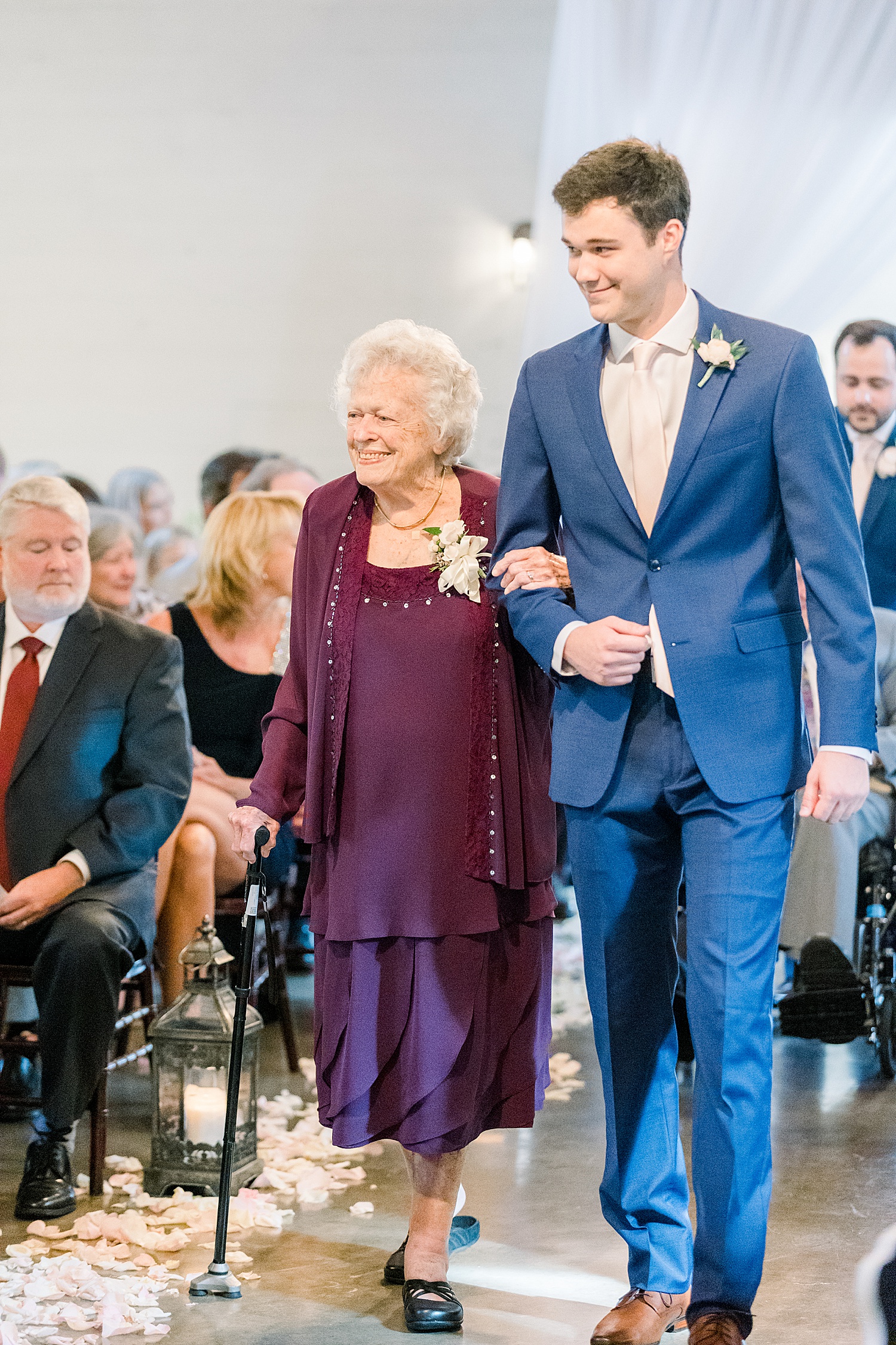 grandmother takes seat at Wedding ceremony at The Barn at Shady Lane in Birmingham, AL