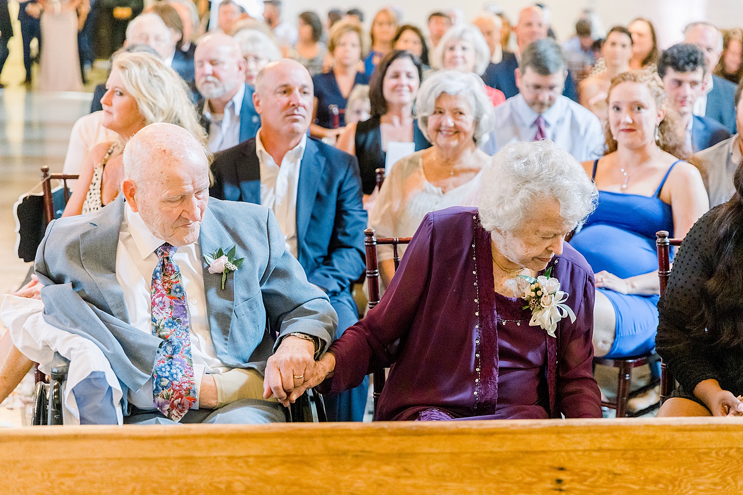 grandmother + grandfather of the bride sit before wedding ceremony
