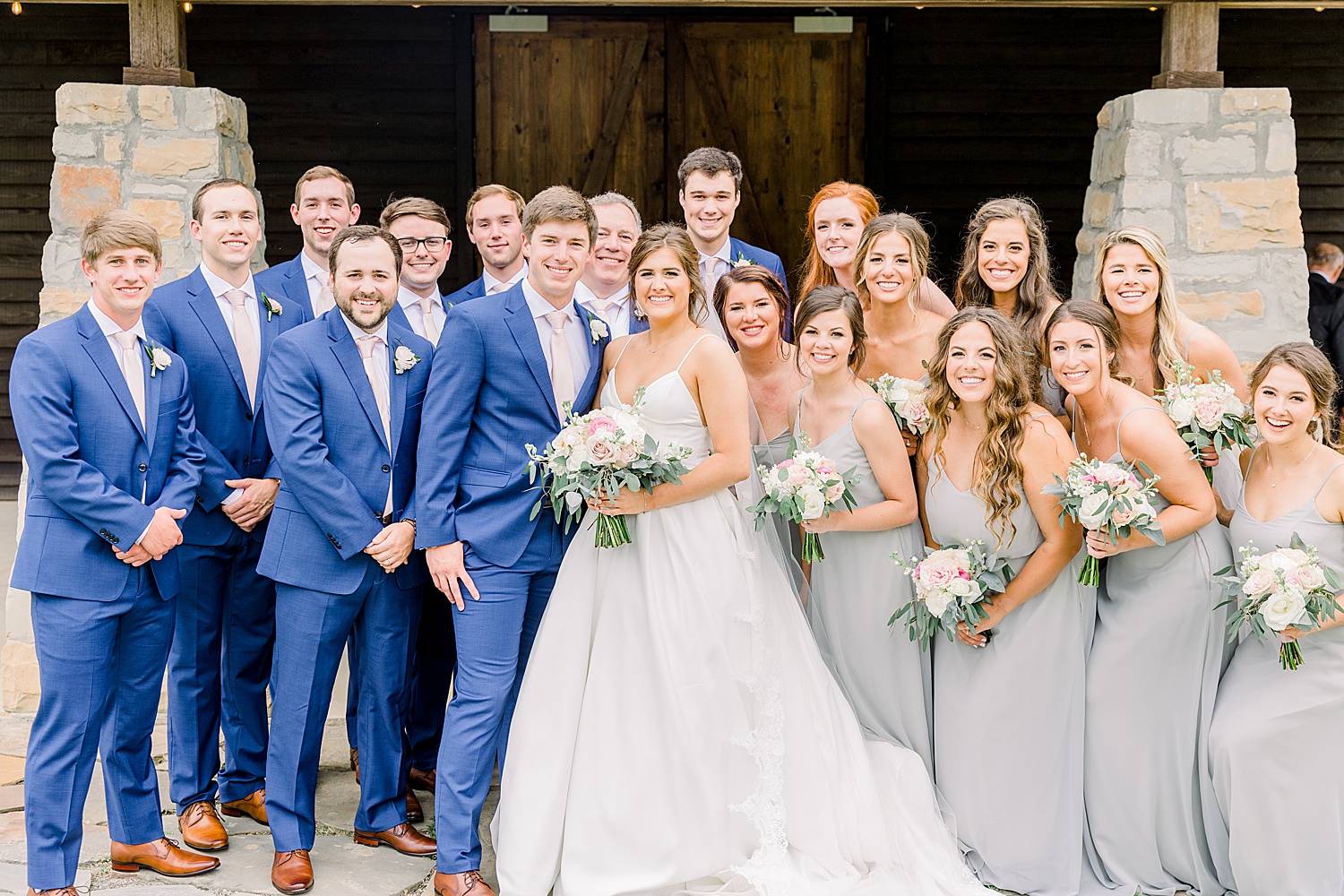 bride + groom surrounded by bridal party during AL wedding captured by Chelsea Morton Photography