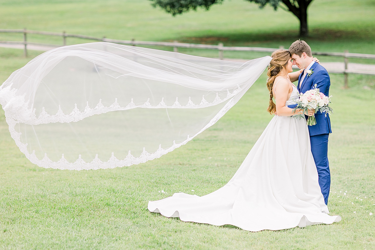 bride and groom after wedding ceremony in AL as Bride's veil flows in the wind