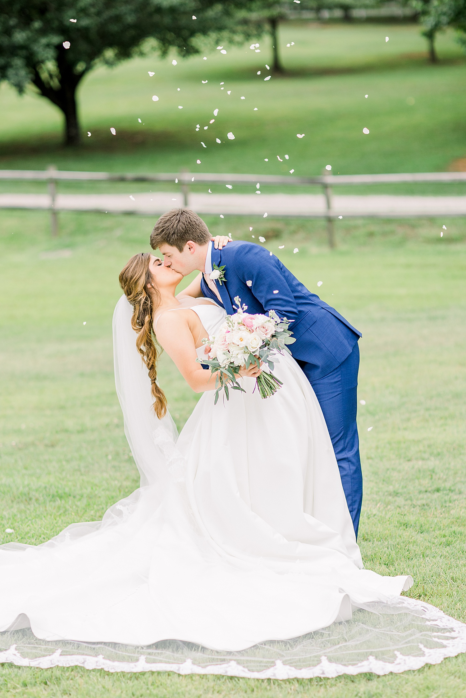 Bride and groom kiss on the grounds of The Barn at Shady Lane in Birmingham AL