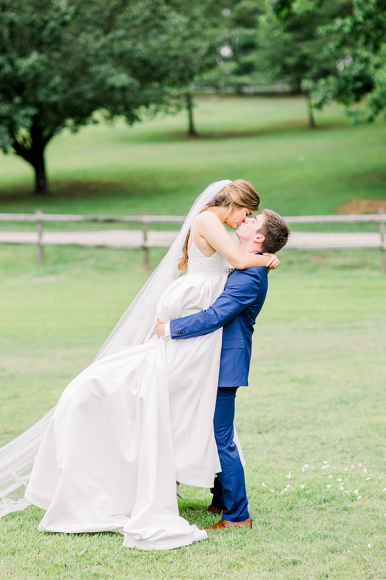husband lifts his new Bride up in his arms