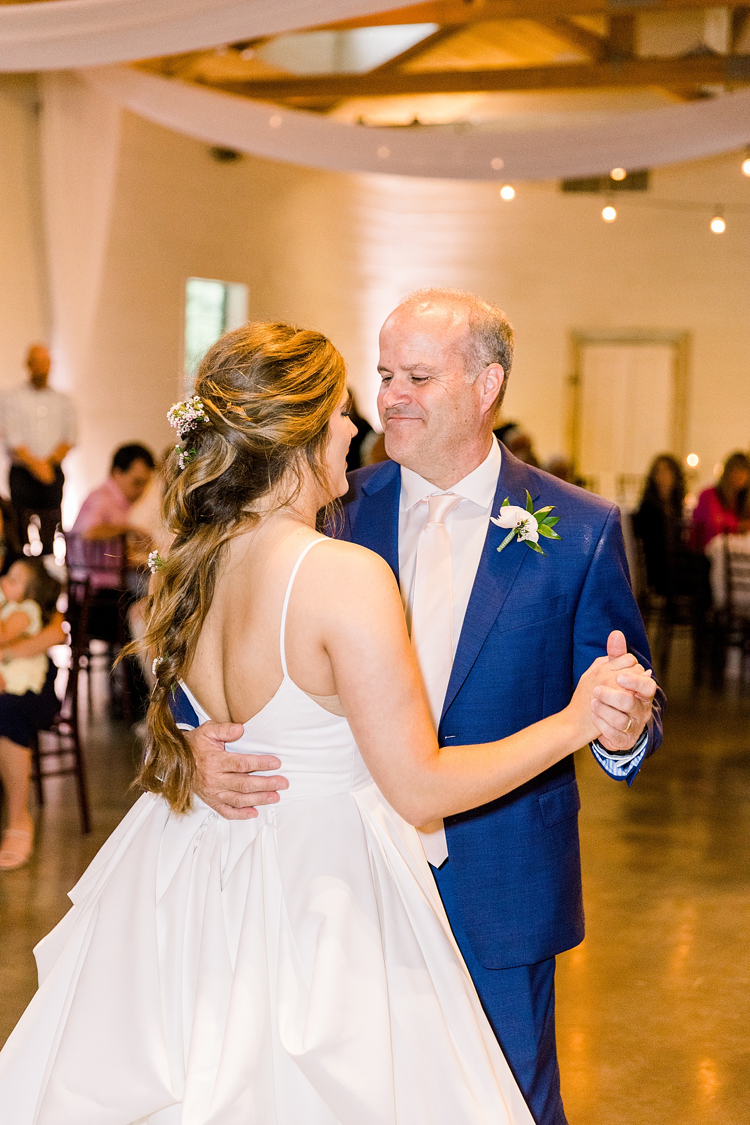 Bride and father during father-daughter dance together during wedding reception